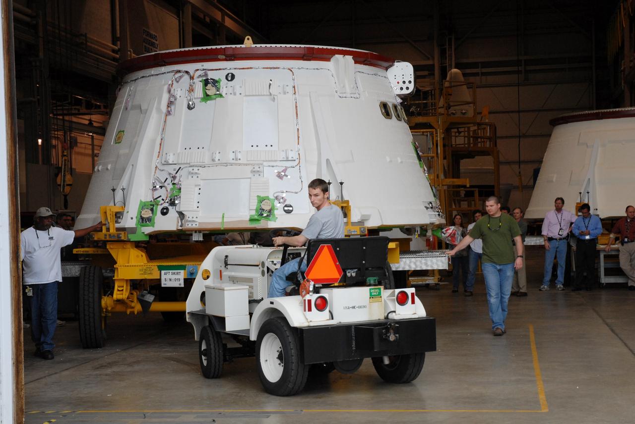 CAPE CANAVERAL, Fla. –  The Ares I-X aft skirt is moved out of the Assembly and Refurbishment Facility to the test building nearby at NASA's Kennedy Space Center in Florida for testing. The I-X flight will provide NASA an early opportunity to test and prove hardware, facilities and ground operations associated with Ares I, part of the Constellation Program to return men to the moon and beyond.  Photo credit: NASA/Troy Cryder