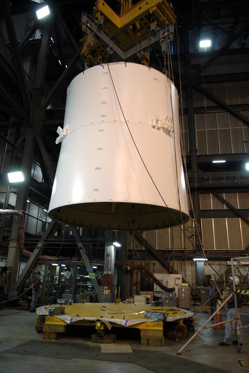 CAPE CANAVERAL, Fla. –  In High Bay 4 of the Vehicle Assembly Building at NASA's Kennedy Space Center in Florida, a large crane lifts the Ares I-X upper stage simulator service module/service adapter segment to move it to a stand. Ares I-X is the test vehicle for the Ares I, which is part of the Constellation Program to return men to the moon and beyond.  The Ares I-X is targeted for launch in July 2009.  Photo credit: NASA/Kim Shiflett