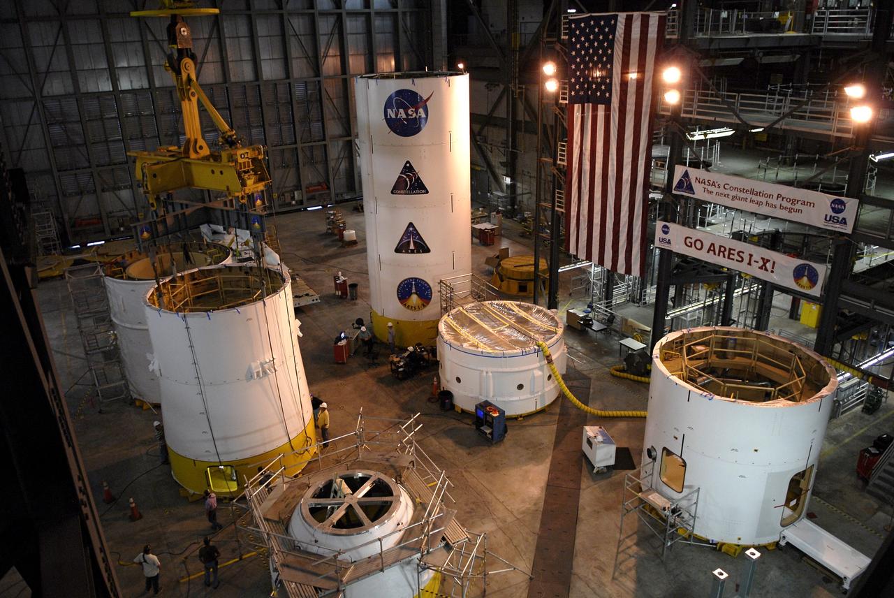 CAPE CANAVERAL, Fla. –  In High Bay 4 of the Vehicle Assembly Building at NASA's Kennedy Space Center in Florida, the Ares I-X upper stage simulator service module/service adapter (left, center) has been installed on a stand. Other segments are placed and stacked on the floor around it.  Ares I-X is the test vehicle for the Ares I, which is part of the Constellation Program to return men to the moon and beyond.  The Ares I-X is targeted for launch in July 2009.  Photo credit: NASA/Kim Shiflett