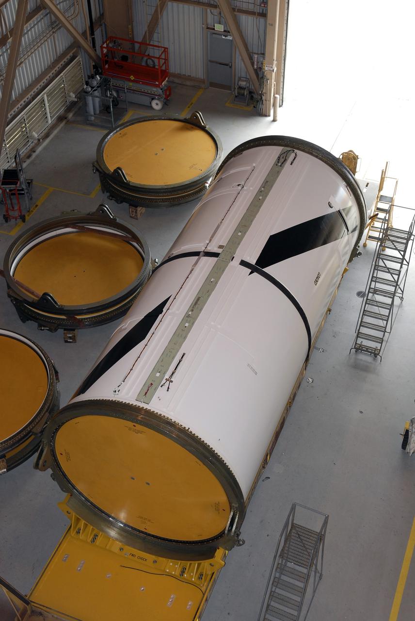 CAPE CANAVERAL, Fla. – In the Rotation, Processing and Surge Facility at NASA's Kennedy Space Center in Florida, the third of four Ares I-X segments arrives on a transporter. The segment will be raised to a vertical position in order to transfer it to a work stand for final processing and integration in the facility. The booster used for the Ares I-X launch is being modified by adding new forward structures and a fifth segment simulator. The stacking operations are scheduled to begin in the Vehicle Assembly Building in April. Launch of the Ares I-X test flight is targeted for July 2009. Photo credit: NASA/Kim Shiflett