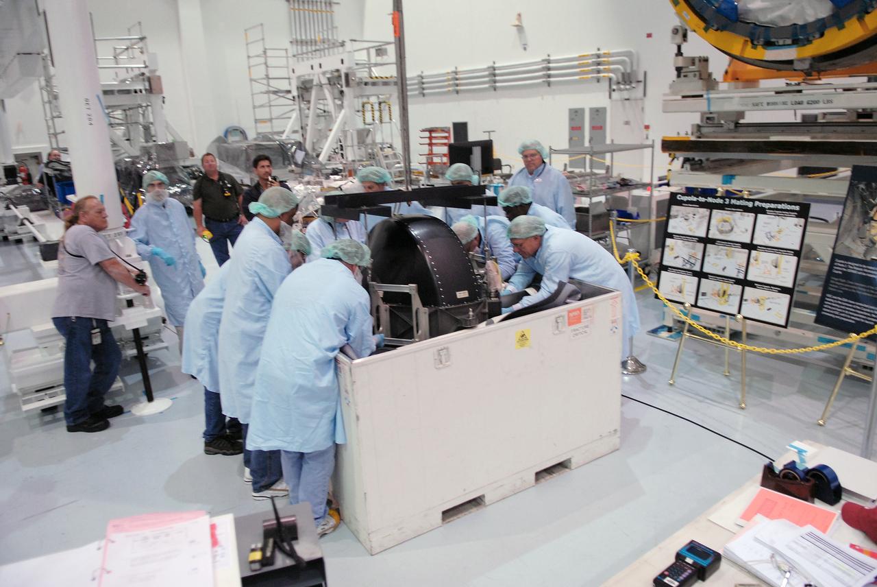 CAPE CANAVERAL, Fla. –  In the Space Station Processing Facility at NASA's Kennedy Space Center in Florida, technicians help lift the control moment gyro, or CMG, from its container.  The CMG is part of the payload on the STS-129 mission to the International Space Station. On the mission, space shuttle Atlantis also will deliver the orbital spares and replacement parts to sustain the life of the station.  Photo credit: NASA/Troy Cryder