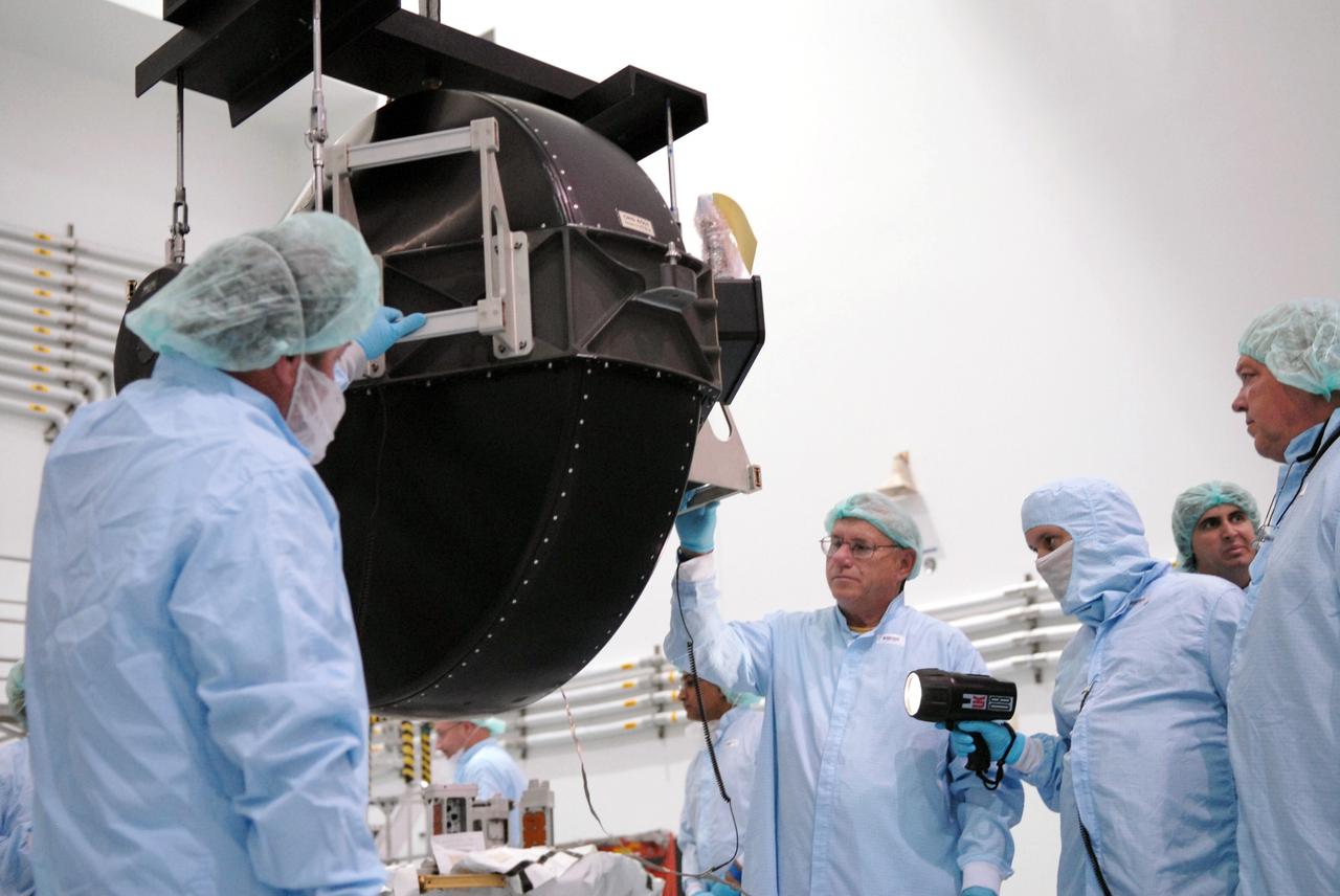 CAPE CANAVERAL, Fla. – In In the Space Station Processing Facility at NASA's Kennedy Space Center in Florida, technicians inspect the control moment gyroscope , or CMG, after removal from its container. The CMG  is suspended by a crane.  The CMG is part of the payload on the STS-129 mission to the International Space Station. On the mission, space shuttle Atlantis also will deliver the orbital spares and replacement parts to sustain the life of the station.  Photo credit: NASA/Troy Cryder
