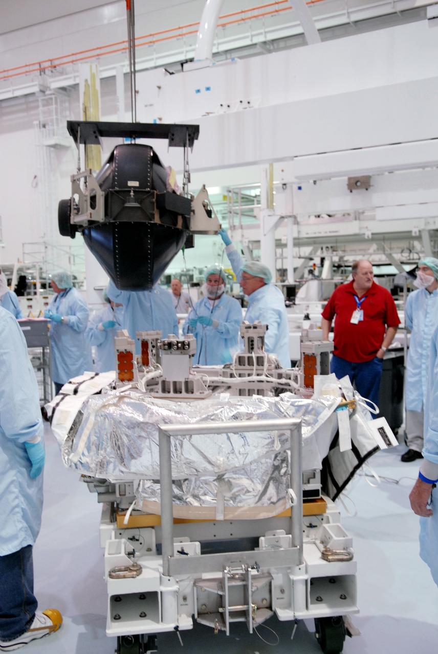 CAPE CANAVERAL, Fla. – In the Space Station Processing Facility at NASA's Kennedy Space Center in Florida,  the control moment gyroscope, or CMG, is moved toward the small adapter plate assembly in the foreground.  The CMG is part of the payload on the STS-129 mission to the International Space Station. On the mission, space shuttle Atlantis also will deliver the orbital spares and replacement parts to sustain the life of the station.  Photo credit: NASA/Troy Cryder