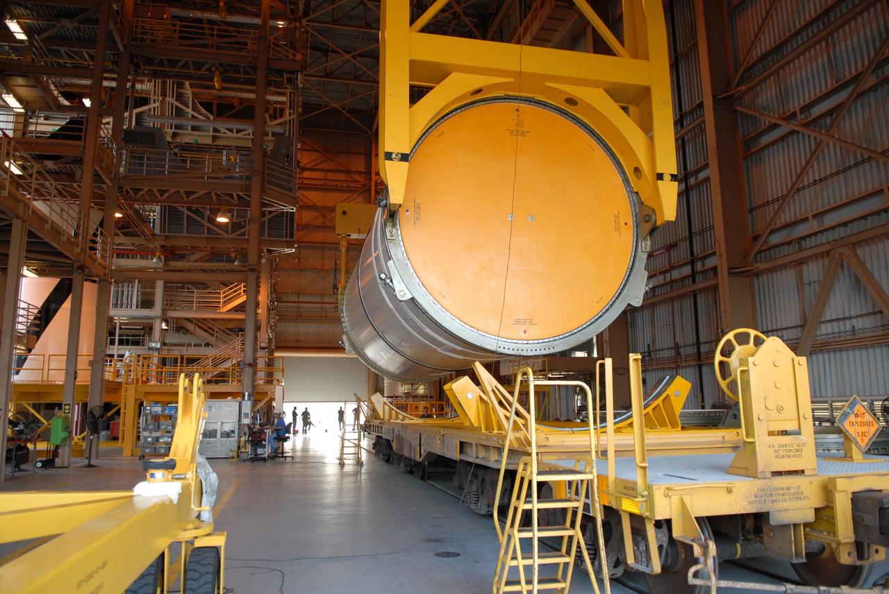 CAPE CANAVERAL, Fla. – In the Rotation, Processing and Surge Facility at NASA's Kennedy Space Center in Florida, cranes attached to the Ares I-X center forward segment lift it off the transporter to raise it to vertical. Once vertical, the segment will be moved to a stand. The booster used for the Ares I-X launch is being modified by adding new forward structures and a fifth segment simulator. The stacking operations are scheduled to begin in the Vehicle Assembly Building in April. Launch of the Ares I-X flight test is targeted for July 2009. Photo credit: NASA/Troy Cryder