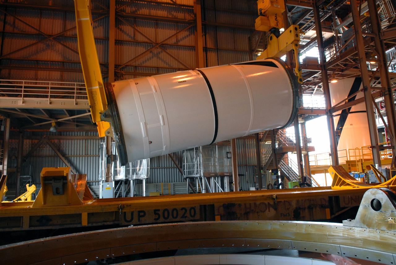 CAPE CANAVERAL, Fla. – In the Rotation, Processing and Surge Facility at NASA's Kennedy Space Center in Florida, cranes attached to the Ares I-X center forward segment lift it off the transporter and begin to raise it to vertical. Once vertical, the segment will be moved to a stand. The booster used for the Ares I-X launch is being modified by adding new forward structures and a fifth segment simulator. The stacking operations are scheduled to begin in the Vehicle Assembly Building in April. Launch of the Ares I-X flight test is targeted for July 2009. Photo credit: NASA/Troy Cryder