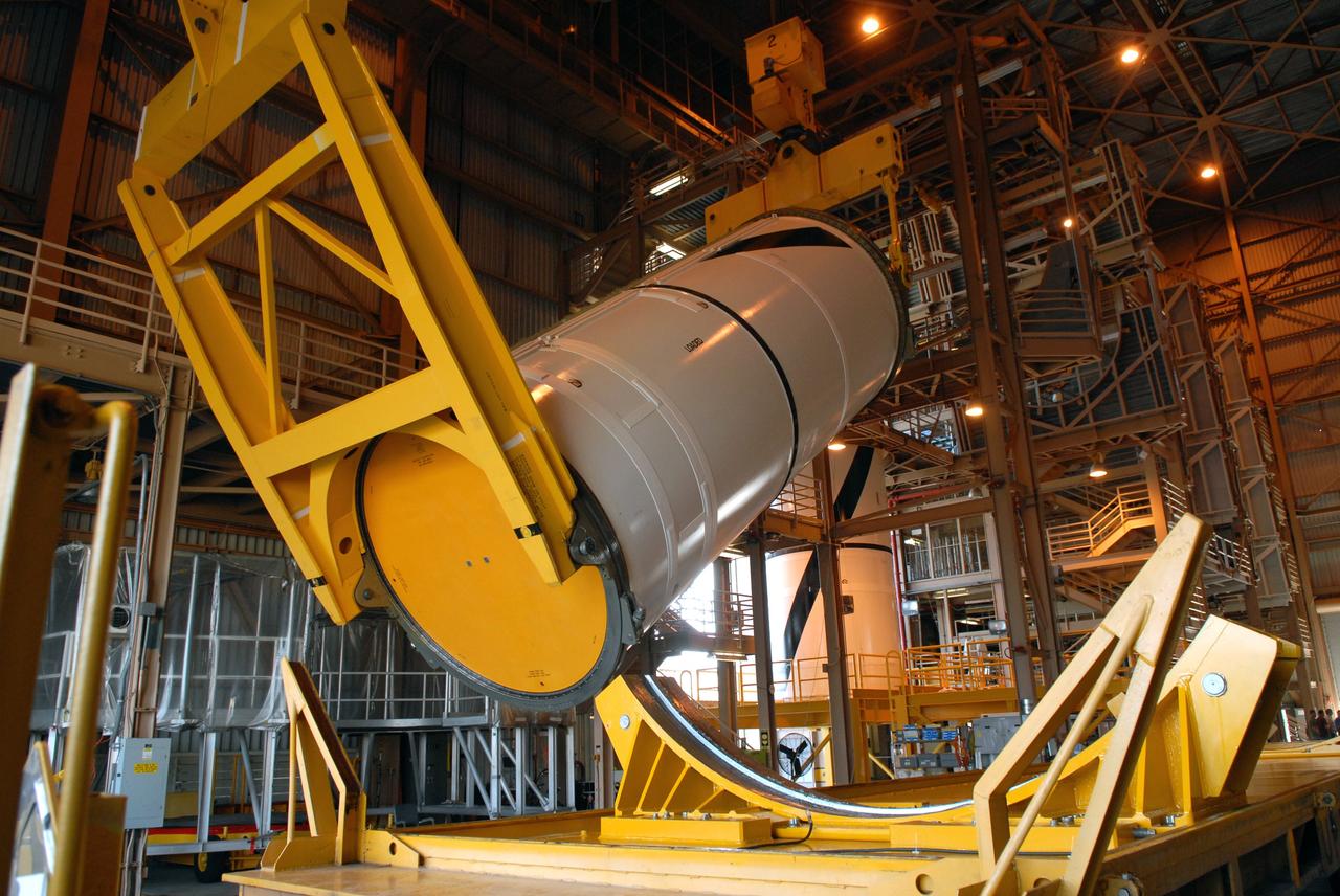 CAPE CANAVERAL, Fla. –  In the Rotation, Processing and Surge Facility at NASA's Kennedy Space Center in Florida, cranes attached to the Ares I-X center forward segment raise it to vertical. Once vertical, the segment will be moved to a stand.  The booster used for the Ares I-X launch is being modified by adding new forward structures and a fifth segment simulator. The stacking operations are scheduled to begin in the Vehicle Assembly Building in April. Launch of the Ares I-X flight test is targeted for July 2009. Photo credit: NASA/Troy Cryder