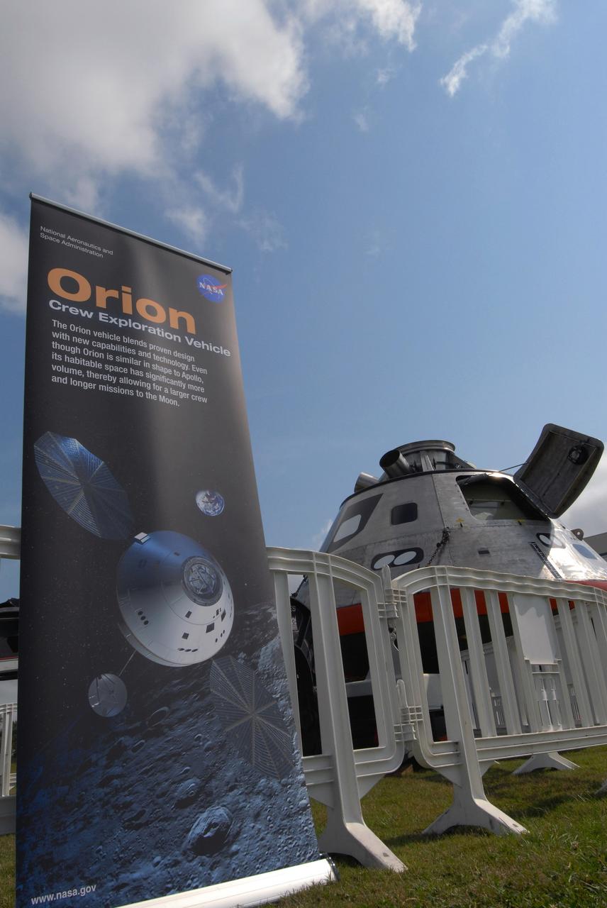 CAPE CANAVERAL, Fla. –  On display at the Kennedy Space Center Visitor Complex in Florida is the Orion crew exploration vehicle mockup (right) and an exhibit about the Constellation Program.  The Orion mockup is on display before heading offshore to be tested in open water. The spacecraft mock-up traveled from the Naval Surface Warfare Center's Carderock Division in Bethesda, Md. The goal of the open water testing, dubbed the Post-landing Orion Recovery Test, or PORT, is to determine what kind of motion astronauts can expect after landing, as well as outside conditions for recovery teams. Part of the Constellation Program, Orion is targeted to begin carrying humans to the International Space Station in 2015 and to the moon by 2020.   Photo credit: NASA/Jack Pfaller