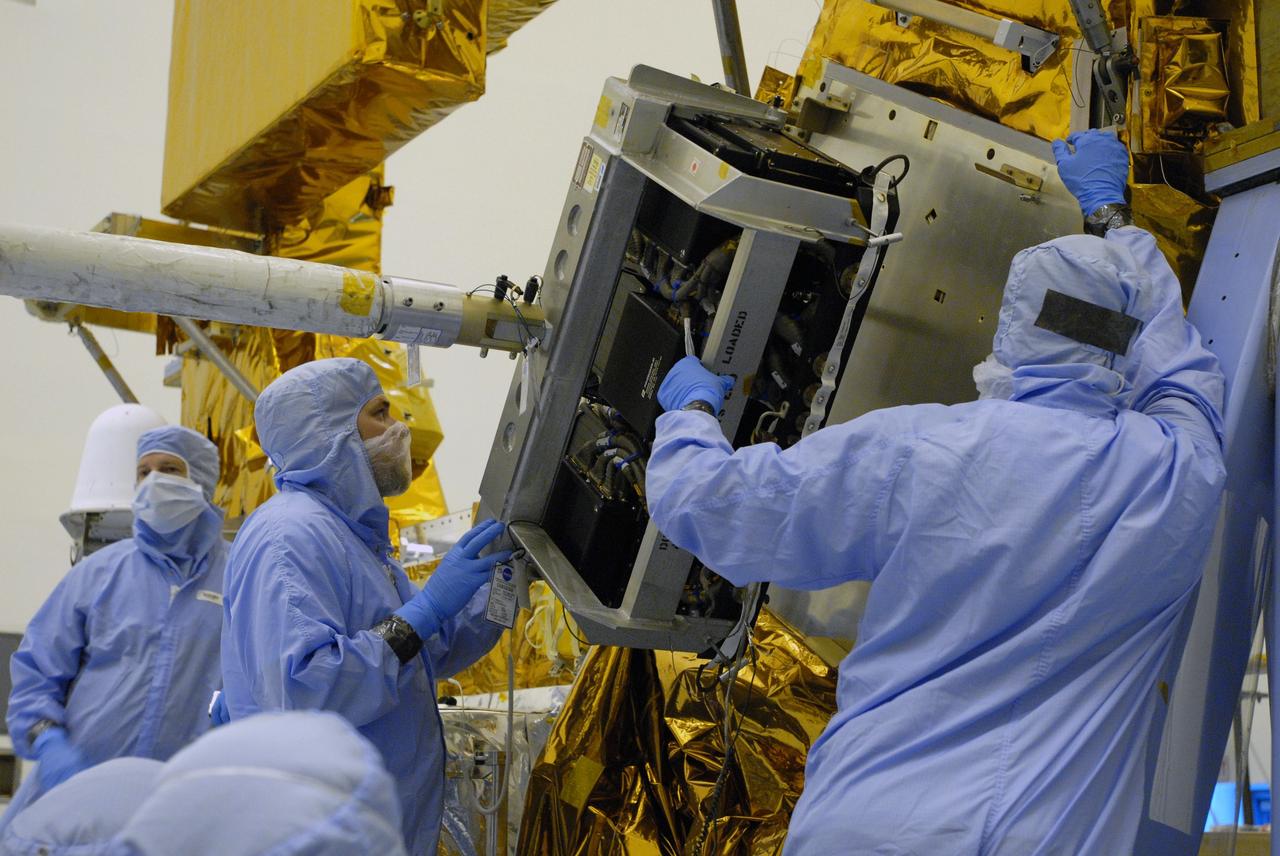 CAPE CANAVERAL, Fla. –  In the Payload Hazardous Servicing Facility at NASA's Kennedy Space Center in Florida, technicians help with the installation of the Science Instrument Command and Data Handling Unit, or SIC&DH, on the Multi-Use Lightweight Equipment Carrier. The SIC&DH will be installed on the Hubble Space Telescope during space shuttle Atlantis' STS-125 mission. This unit will replace the one that suffered a failure aboard the orbiting telescope on Sept. 27, 2008. Atlantis is targeted for launch on May 12.  Photo credit: NASA/Dimitri Gerondidakis