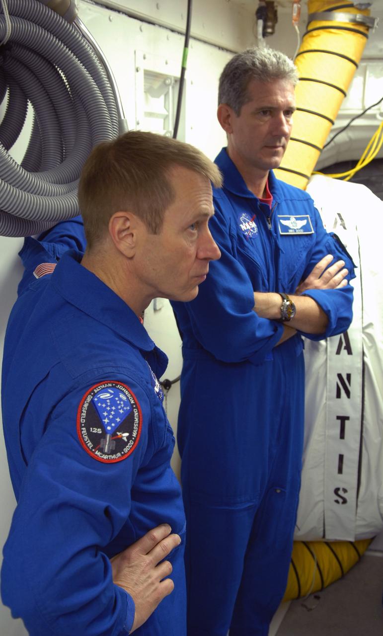 CAPE CANAVERAL, Fla. – Inside Inside the White Room on Launch Pad 39A at NASA's Kennedy Space Center in Florida, STS-125 Pilot Gregory C. Johnson (left) and Mission Specialist Michael Good listen to review procedures for entry into space shuttle Atlantis.   Space shuttle Atlantis' 11-day flight is targeted for launch May 12 and will include five spacewalks to refurbish and upgrade the telescope with state-of-the-art science instruments. As a result, Hubble's capabilities will be expanded and its operational lifespan extended through at least 2014.  Photo credit: NASA/Cory Huston