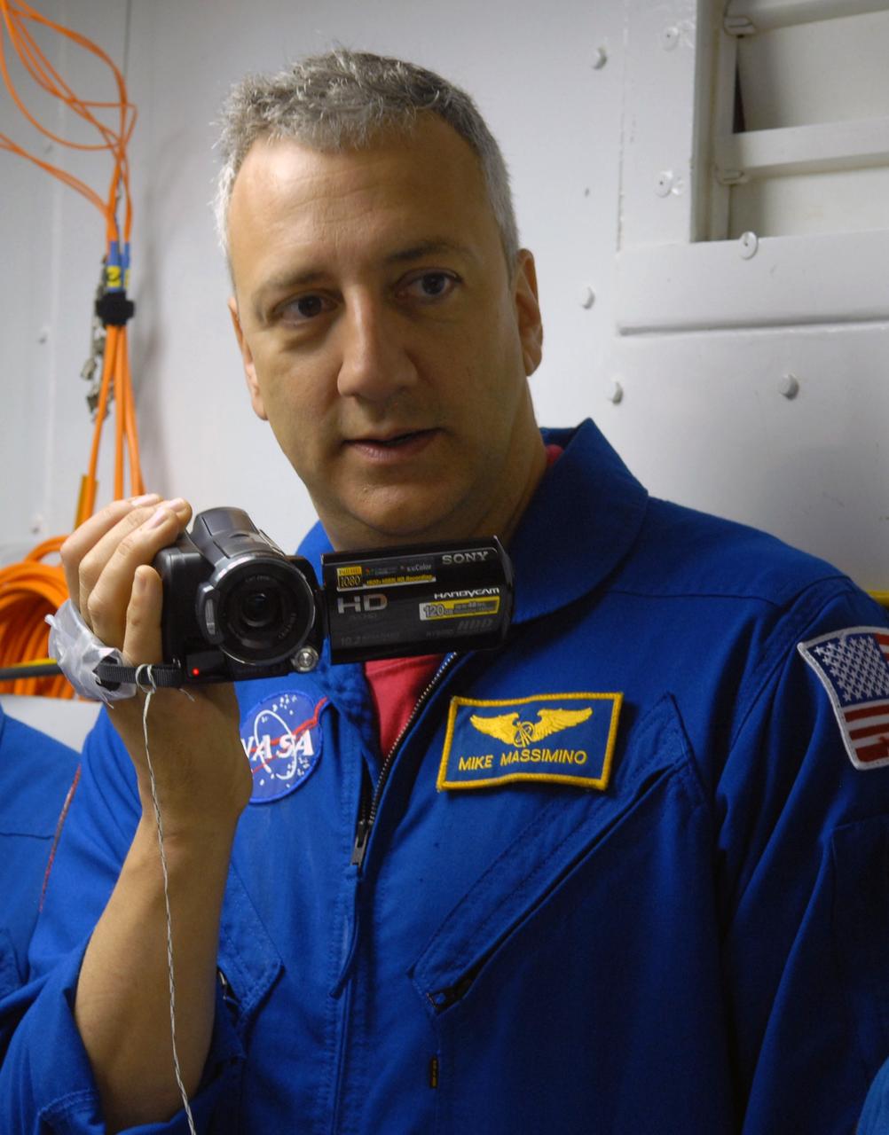 CAPE CANAVERAL, Fla. – Inside the White Room on Launch Pad 39A at NASA's Kennedy Space Center in Florida, STS-125 Mission Specialist Mike Massimino records the review procedures  for entry into space shuttle Atlantis.  Space shuttle Atlantis' 11-day flight is targeted for launch May 12 and will include five spacewalks to refurbish and upgrade the telescope with state-of-the-art science instruments. As a result, Hubble's capabilities will be expanded and its operational lifespan extended through at least 2014.  Photo credit: NASA/Cory Huston