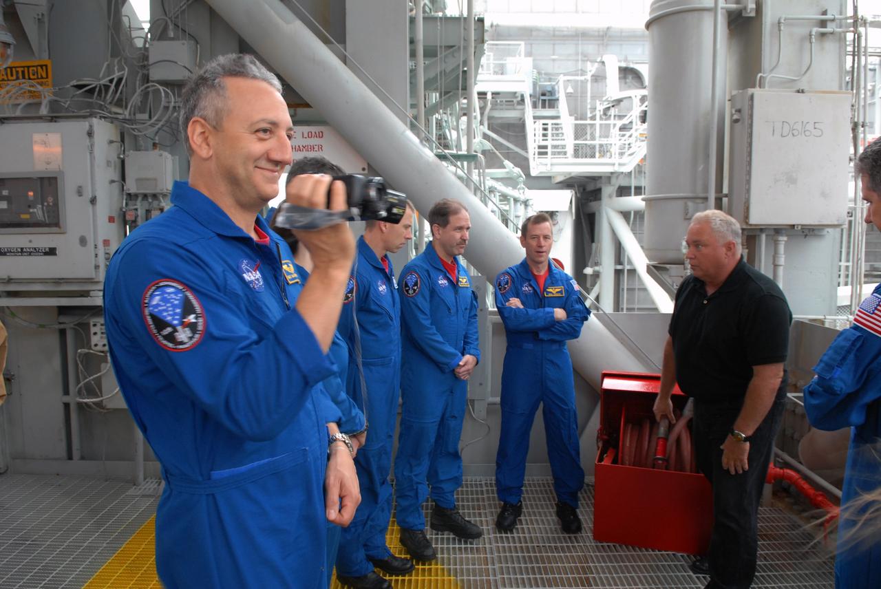 CAPE CANAVERAL, Fla. – On the fixed service structure on Launch Pad 39A at NASA's Kennedy Space Center in Florida, STS-125 crew members review emergency exit procedures. From left are Mission Specialist Mike Massimino, Andrew Feustel and John Grunsfeld and Pilot Gregory C. Johnson.  Space shuttle Atlantis' 11-day flight is targeted for launch May 12 and will include five spacewalks to refurbish and upgrade the telescope with state-of-the-art science instruments. As a result, Hubble's capabilities will be expanded and its operational lifespan extended through at least 2014.  Photo credit: NASA/Cory Huston