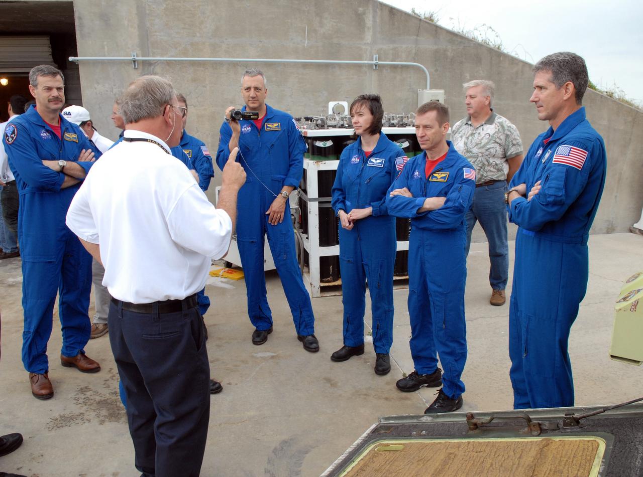 CAPE CANAVERAL, Fla. – Near the bunker on Launch Pad 39A at NASA's Kennedy Space Center in Florida, STS-125 crew members listen to a trainer review emergency exit procedures from the pad.  From left are Commander Scott Altman, Mission Specialists Mike Massimino and Megan McArthur, Pilot Gregory C. Johnson and Mission Specialist Michael Good. Not clearly visible are Mission Specialists Andrew Feustel and John Grunsfeld. Space shuttle Atlantis' 11-day flight is targeted for launch May 12 and will include five spacewalks to refurbish and upgrade the telescope with state-of-the-art science instruments. As a result, Hubble's capabilities will be expanded and its operational lifespan extended through at least 2014.  Photo credit: NASA/Cory Huston