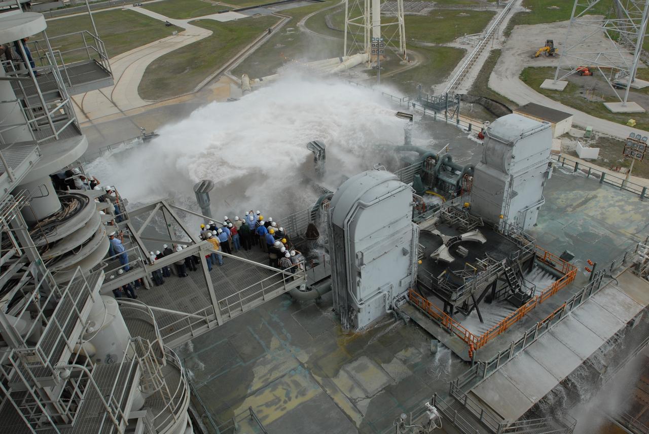 CAPE CANAVERAL, Fla. – The sound suppression system is tested on the mobile launcher platform on Launch Pad 39B at NASA's Kennedy Space Center in Florida. Pad 39B will be the site of the first Ares vehicle launch, including the Ares I-X flight test that is targeted for summer 2009. The mobile launcher platform was handed over to the Constellation Program and modified for the Ares I-X flight test. It is being tested before being moved to the Vehicle Assembly Building for assembly of the Ares I-X rocket. A sound suppression water system is in¬stalled on the pads to protect against damage by acoustical energy and rocket exhaust reflected from the flame trench and mobile launcher plat¬form during a launch. The sound suppression system includes an elevated 290-foot-high water tank with a capacity of 300,000 gallons. The water releases just prior to the ignition of the rocket and flows through 7-foot-diameter pipes for about 20 seconds. A torrent of water will flow onto the mobile launcher platform from six large quench nozzles, or “rainbirds,” mounted on its surface. The rainbirds are 12 feet high. The two in the center are 42 inches in diameter; the other four have a 30-inch diameter. Photo credit: NASA/Jim Grossmann