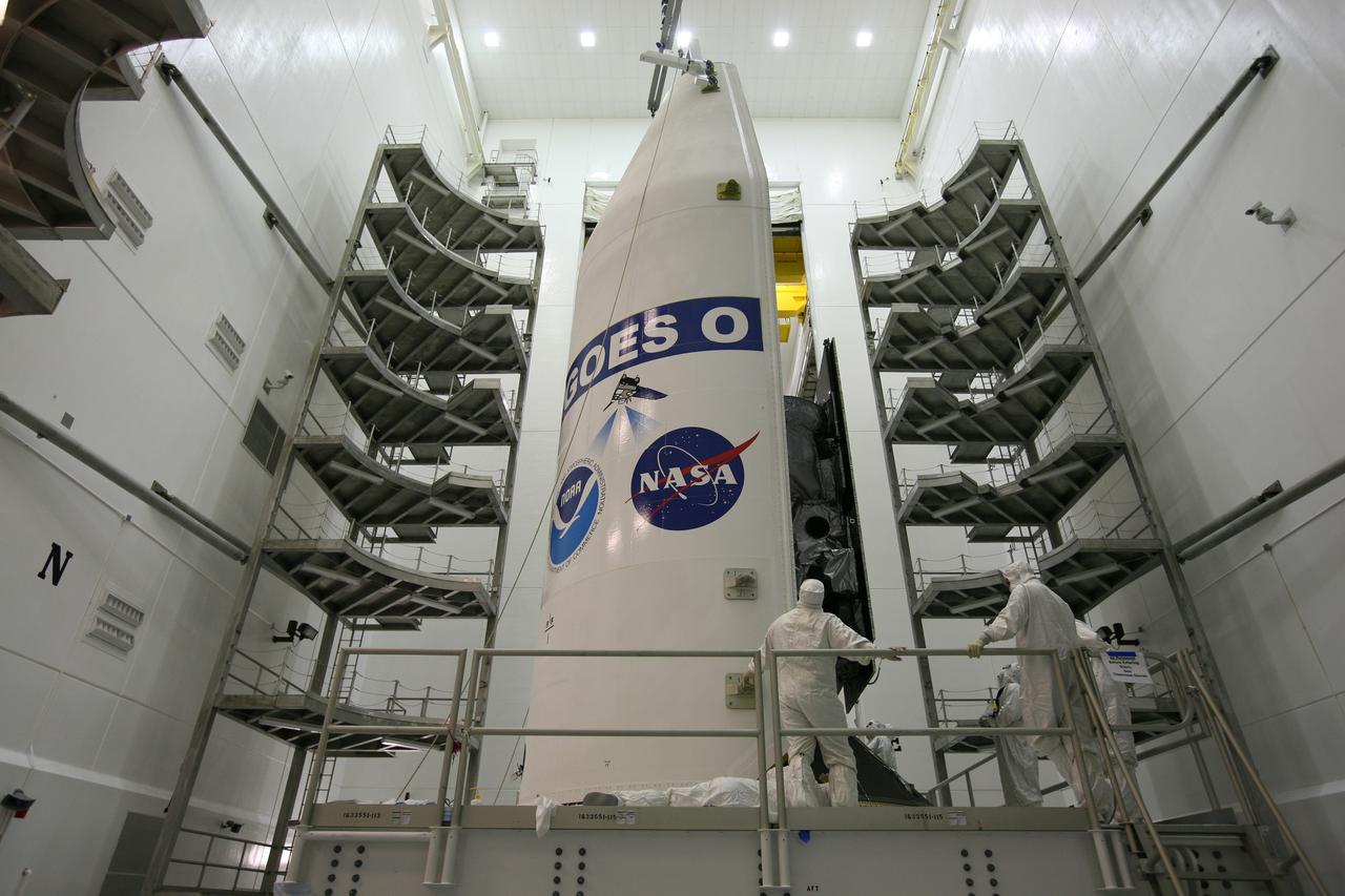 CAPE CANAVERAL, Fla. – In the Astrotech payload processing facility in Titusville, Fla., the first half of the payload fairing is moved around the GOES-O satellite. The fairing is a molded structure that fits flush with the outside surface of the rocket and forms an aerodynamically smooth nose cone, protecting the spacecraft during launch and ascent. The latest Geostationary Operational Environmental Satellite, GOES-O was developed by NASA for the National Oceanic and Atmospheric Administration, or NOAA. The GOES satellites continuously provide observations of 60 percent of the Earth including the continental United States, providing weather monitoring and forecast operations as well as a continuous and reliable stream of environmental information and severe weather warnings. Once in orbit, GOES-O will be designated GOES-14, and NASA will provide on-orbit checkout and then transfer operational responsibility to NOAA. The GOES-O satellite is targeted to launch from Cape Canaveral Air Force Station's Launch Complex 37 on April 28 onboard a United Launch Alliance Delta IV expendable launch vehicle. Photo credit: NASA/Dimitri Gerondidakis