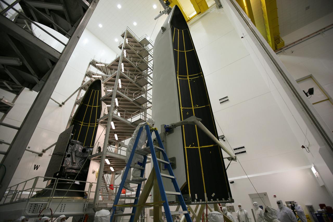 CAPE CANAVERAL, Fla. – In the Astrotech payload processing facility in Titusville, Fla., the first half of the payload fairing has been placed around the GOES-O satellite, at left. At right, the second half has been lifted to vertical for its placement around GOES-O to complete the encapsulation. The fairing is a molded structure that fits flush with the outside surface of the rocket and forms an aerodynamically smooth nose cone, protecting the spacecraft during launch and ascent. The latest Geostationary Operational Environmental Satellite, GOES-O was developed by NASA for the National Oceanic and Atmospheric Administration, or NOAA. The GOES satellites continuously provide observations of 60 percent of the Earth including the continental United States, providing weather monitoring and forecast operations as well as a continuous and reliable stream of environmental information and severe weather warnings. Once in orbit, GOES-O will be designated GOES-14, and NASA will provide on-orbit checkout and then transfer operational responsibility to NOAA. The GOES-O satellite is targeted to launch from Cape Canaveral Air Force Station's Launch Complex 37 on April 28 onboard a United Launch Alliance Delta IV expendable launch vehicle. Photo credit: NASA/Dimitri Gerondidakis