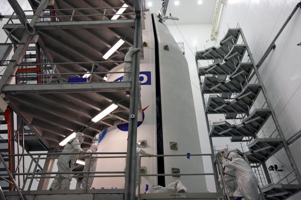 CAPE CANAVERAL, Fla. – In the Astrotech payload processing facility in Titusville, Fla., technicians monitor the closing of the two halves of the payload fairing around the GOES-O satellite. The fairing is a molded structure that fits flush with the outside surface of the rocket and forms an aerodynamically smooth nose cone, protecting the spacecraft during launch and ascent. The latest Geostationary Operational Environmental Satellite, GOES-O was developed by NASA for the National Oceanic and Atmospheric Administration, or NOAA. The GOES satellites continuously provide observations of 60 percent of the Earth including the continental United States, providing weather monitoring and forecast operations as well as a continuous and reliable stream of environmental information and severe weather warnings. Once in orbit, GOES-O will be designated GOES-14, and NASA will provide on-orbit checkout and then transfer operational responsibility to NOAA. The GOES-O satellite is targeted to launch from Cape Canaveral Air Force Station's Launch Complex 37 on April 28 onboard a United Launch Alliance Delta IV expendable launch vehicle. Photo credit: NASA/Dimitri Gerondidakis