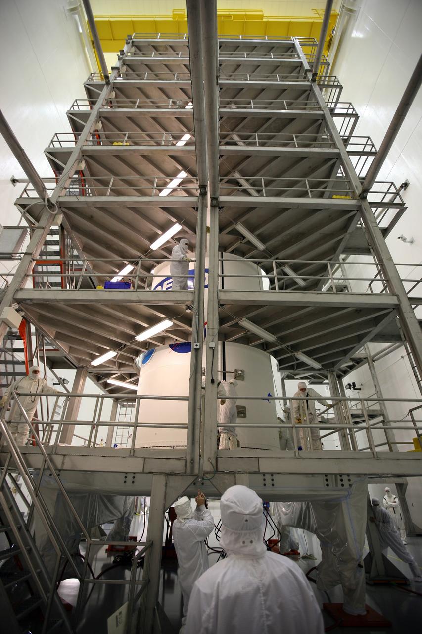 CAPE CANAVERAL, Fla. – In the Astrotech payload processing facility in Titusville, Fla., technicians complete the installation of the payload fairing around the GOES-O satellite. The fairing is a molded structure that fits flush with the outside surface of the rocket and forms an aerodynamically smooth nose cone, protecting the spacecraft during launch and ascent. The latest Geostationary Operational Environmental Satellite, GOES-O was developed by NASA for the National Oceanic and Atmospheric Administration, or NOAA. The GOES satellites continuously provide observations of 60 percent of the Earth including the continental United States, providing weather monitoring and forecast operations as well as a continuous and reliable stream of environmental information and severe weather warnings. Once in orbit, GOES-O will be designated GOES-14, and NASA will provide on-orbit checkout and then transfer operational responsibility to NOAA. The GOES-O satellite is targeted to launch from Cape Canaveral Air Force Station's Launch Complex 37 on April 28 onboard a United Launch Alliance Delta IV expendable launch vehicle. Photo credit: NASA/Dimitri Gerondidakis