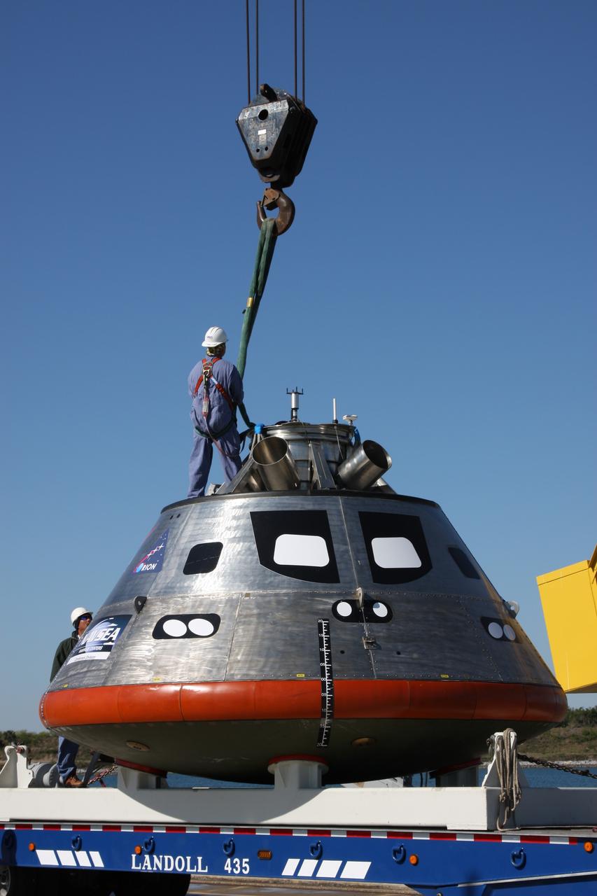CAPE CANAVERAL, Fla. – The mockup Orion crew exploration vehicle is prepared to be lifted into the water at the Trident Basin at Port Canaveral, Fla., for testing. Orion is targeted to begin carrying humans to the International Space Station in 2015 and to the moon by 2020. The goal of the operation, dubbed the Post-landing Orion Recovery Test, or PORT, is to determine what kind of motion astronauts can expect after landing, as well as outside conditions for recovery teams.  Orion, along with the Ares I and V rockets and the Altair lunar lander, are part of the Constellation Program.  Photo credit: NASA/Dimitri Gerondidakis