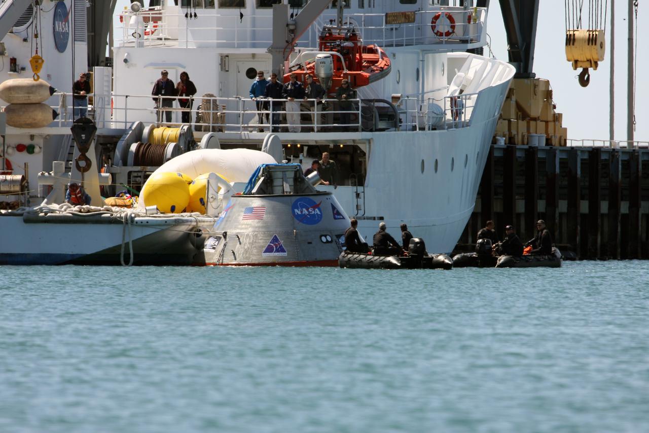 CAPE CANAVERAL, Fla. – The mockup Orion crew exploration vehicle floats in the water at the Trident Basin at Port Canaveral, Fla.  Orion is targeted to begin carrying humans to the International Space Station in 2015 and to the moon by 2020. The mockup vehicle will undergo testing in open water.  The goal of the operation, dubbed the Post-landing Orion Recovery Test, or PORT, is to determine what kind of motion astronauts can expect after landing, as well as outside conditions for recovery teams.  Orion, along with the Ares I and V rockets and the Altair lunar lander, are part of the Constellation Program.  Photo credit: NASA/Dimitri Gerondidakis