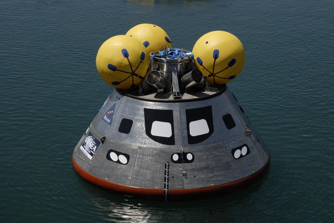 CAPE CANAVERAL, Fla. – The mockup Orion crew exploration vehicle floats in the water at the Trident Basin at Port Canaveral, Fla.  On top of Orion are additional flotation devices. Orion is targeted to begin carrying humans to the International Space Station in 2015 and to the moon by 2020.  The mockup vehicle is undergoing testing in open water. The goal of the operation, dubbed the Post-landing Orion Recovery Test, or PORT, is to determine what kind of motion astronauts can expect after landing, as well as outside conditions for recovery teams.  Orion, along with the Ares I and V rockets and the Altair lunar lander, are part of the Constellation Program.  Photo credit: NASA/Kim Shiflett