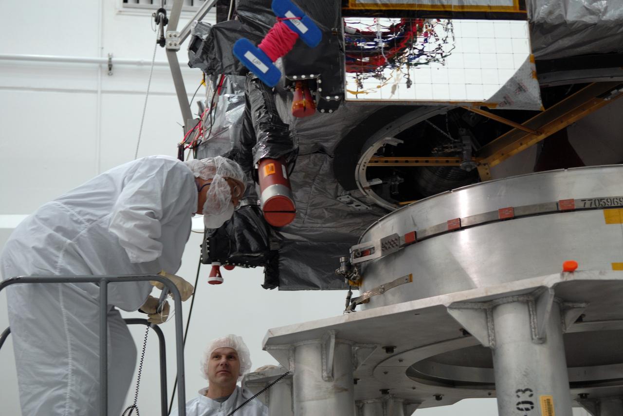 CAPE CANAVERAL, Fla. – In the Astrotech payload processing facility in Titusville, Fla., technicians monitor the alignment of the GOES-O satellite onto a special stand for loading of its oxidizer and hydrazine propellants. The latest Geostationary Operational Environmental Satellite, GOES-O was developed by NASA for the National Oceanic and Atmospheric Administration, or NOAA. The GOES satellites continuously provide observations of 60 percent of the Earth including the continental United States, providing weather monitoring and forecast operations as well as a continuous and reliable stream of environmental information and severe weather warnings. Once in orbit, GOES-O will be designated GOES-14, and NASA will provide on-orbit checkout and then transfer operational responsibility to NOAA. The GOES-O satellite is targeted to launch from Cape Canaveral Air Force Station's Launch Complex 37 no earlier than May 12 onboard a United Launch Alliance Delta IV expendable launch vehicle.  Photo credit: NASA/Troy Cryder