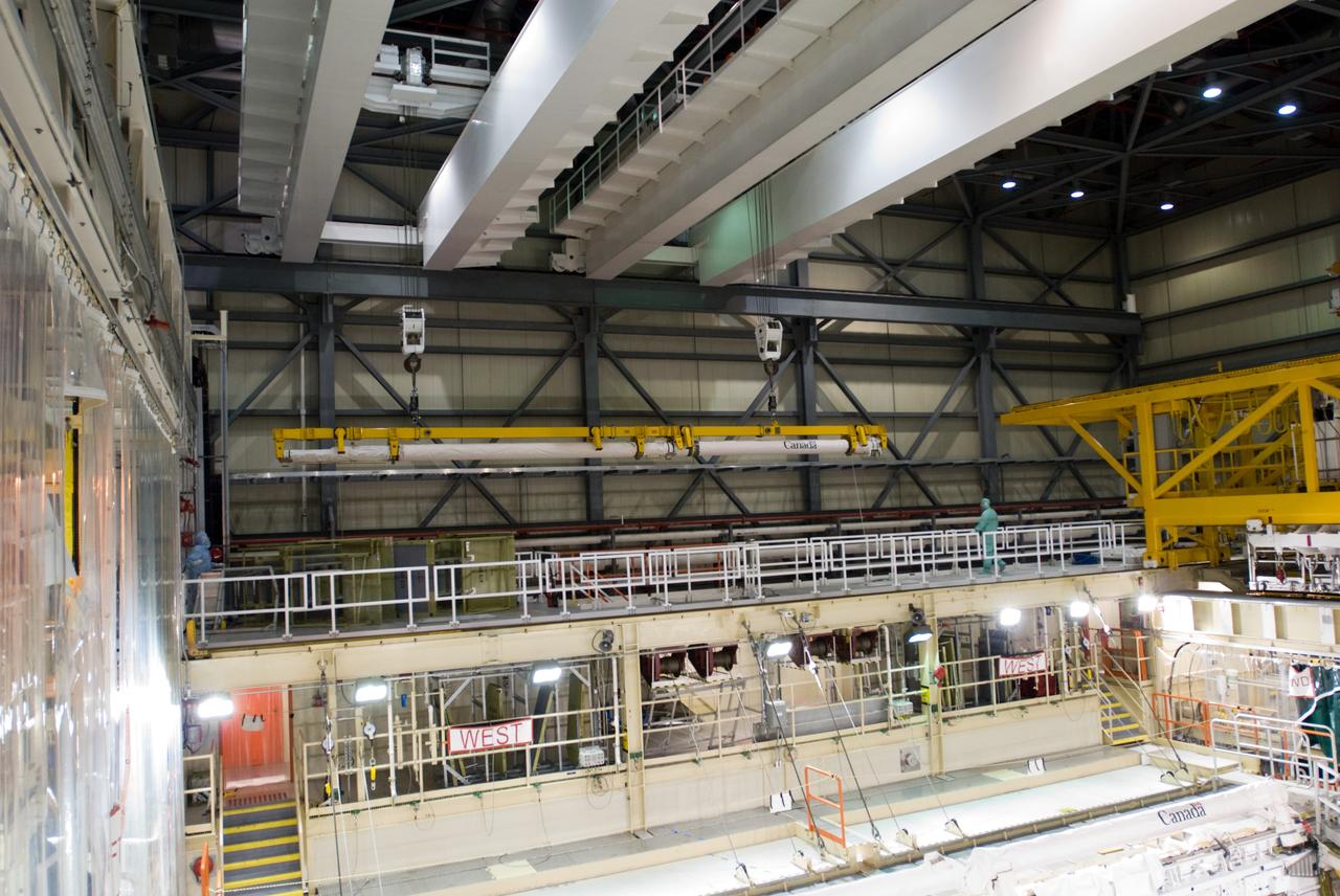 CAPE CANAVERAL, Fla. – In the Orbiter Processing Facility’s bay 3, the orbiter boom sensor system is lifted by a crane for installation in space shuttle Discovery’s payload bay for mission STS-128. The 50-foot-long boom attaches to the shuttle arm and provides equipment to inspect the shuttle's heat shield while in space. It contains an intensified television camera (ITVC) and a laser dynamic range imager, which are mounted on a pan and tilt unit, and a laser camera system (LCS) mounted on a stationary bracket.  The STS-128 flight will carry science and storage racks to the International Space Station on space shuttle Discovery. Launch of Discovery is targeted for Aug. 6. Photo credit: NASA/Jim Grossmann