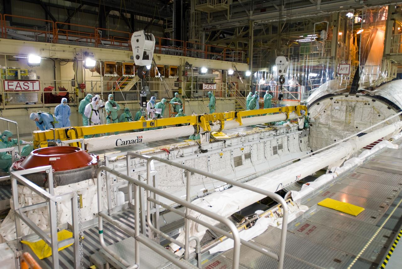 CAPE CANAVERAL, Fla. – In the Orbiter Processing Facility’s bay 3, the orbiter boom sensor system is installed in the payload bay of space shuttle Discovery to support mission STS-128. The 50-foot-long boom attaches to the shuttle arm and provides equipment to inspect the shuttle's heat shield while in space. It contains an intensified television camera (ITVC) and a laser dynamic range imager, which are mounted on a pan and tilt unit, and a laser camera system (LCS) mounted on a stationary bracket.  The STS-128 flight will carry science and storage racks to the International Space Station on space shuttle Discovery. Launch of Discovery is targeted for Aug. 6. Photo credit: NASA/Jim Grossmann