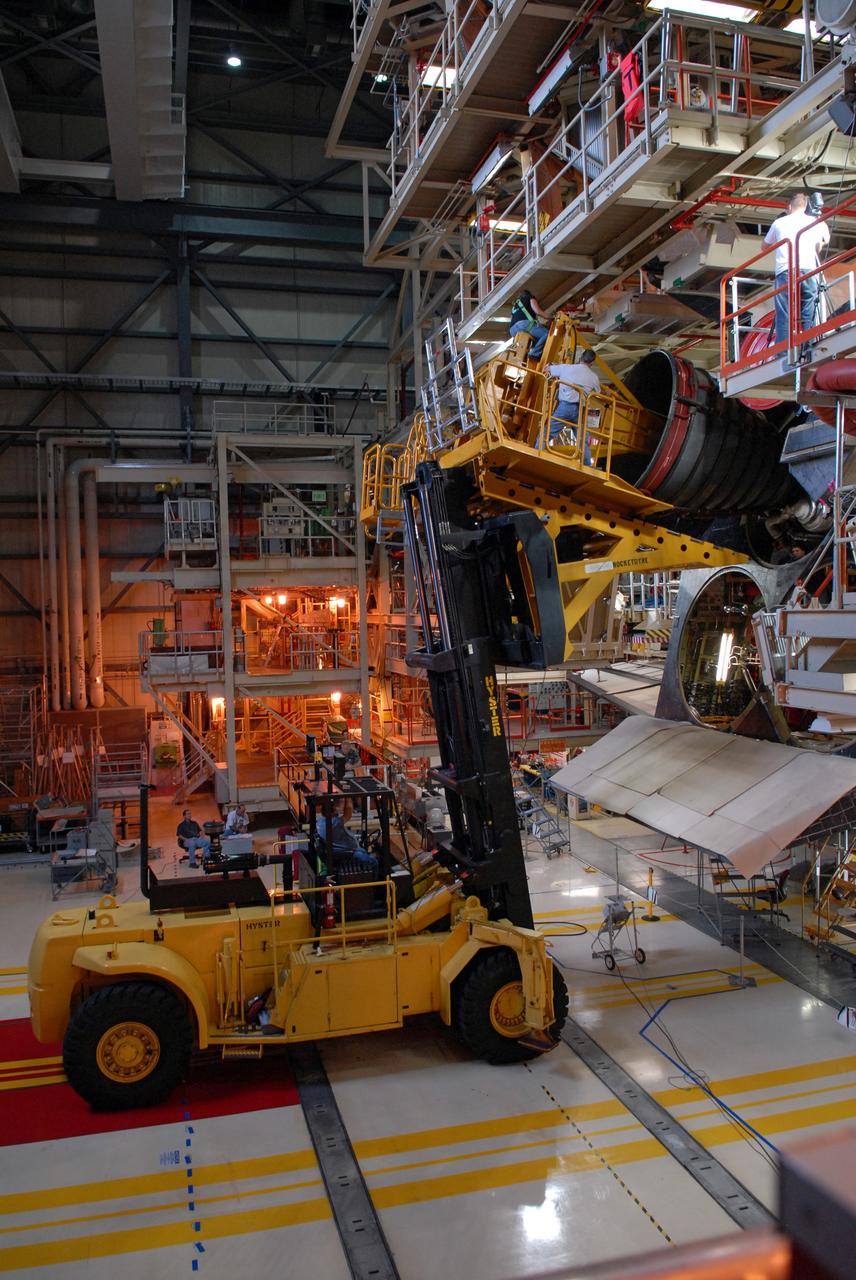 CAPE CANAVERAL, Fla. – At NASA's Kennedy Space Center in Florida, technicians using a Hyster forklift "stab" one of the three main engines on space shuttle Discovery to remove it.  Engine removal is part of the post-landing processing.  Discovery completed the STS-119 mission March 28 with a landing at Kennedy's Shuttle Landing Facility. Each engine is 14 feet long, weighs about 6,700 pounds, and is 7.5 feet in diameter at the end of the nozzle. Discovery next will be used on the STS-128 mission to deliver supplies and equipment to the International Space Station.  The launch is targeted for Aug. 6.  Photo credit: NASA/Tim Jacobs