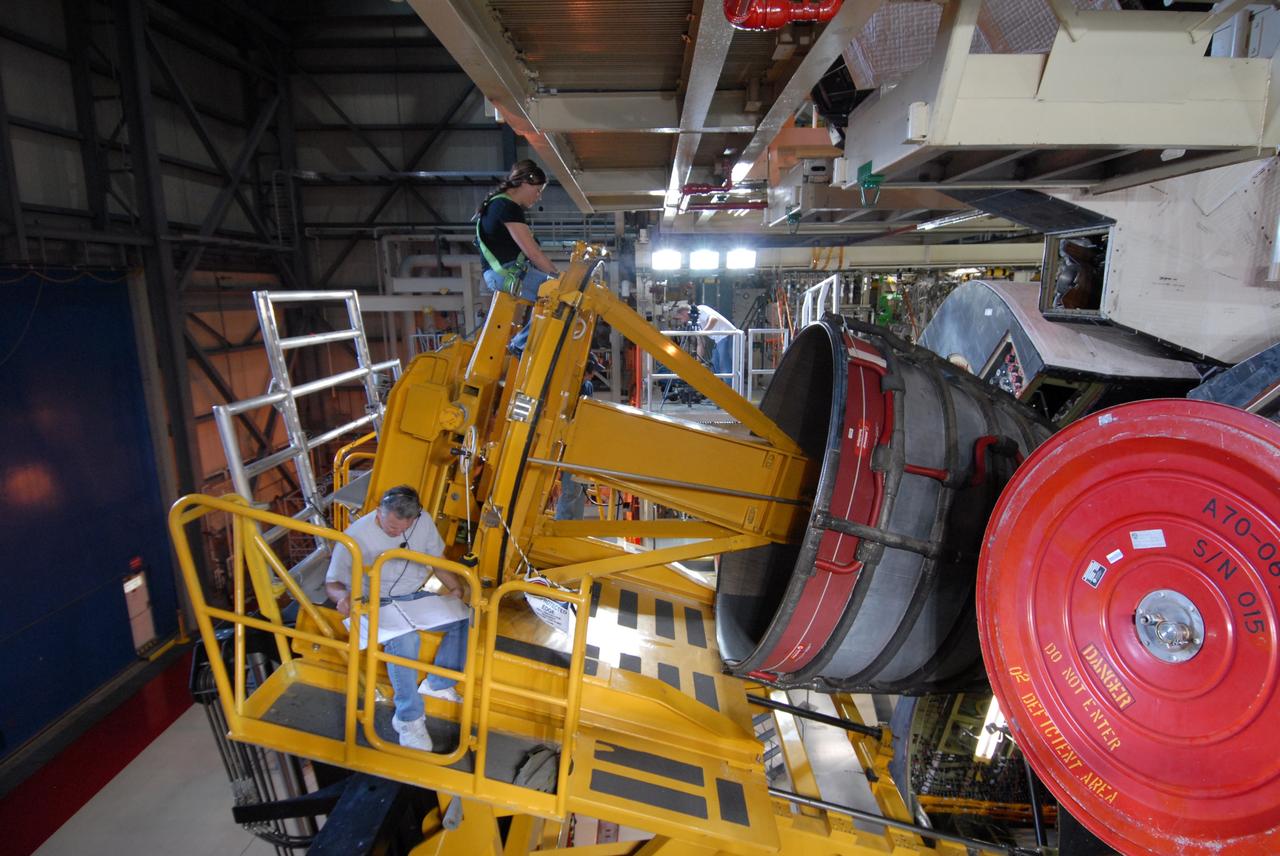 CAPE CANAVERAL, Fla. – At NASA's Kennedy Space Center in Florida, technicians using a Hyster forklift prepare to remove one of the three main engines on space shuttle Discovery.  Engine removal is part of the post-landing processing.  Discovery completed the STS-119 mission March 28 with a landing at Kennedy's Shuttle Landing Facility.  Each engine is 14 feet long, weighs about 6,700 pounds, and is 7.5 feet in diameter at the end of the nozzle. Discovery next will be used on the STS-128 mission to deliver supplies and equipment to the International Space Station.  The launch is targeted for Aug. 6.  Photo credit: NASA/Tim Jacobs