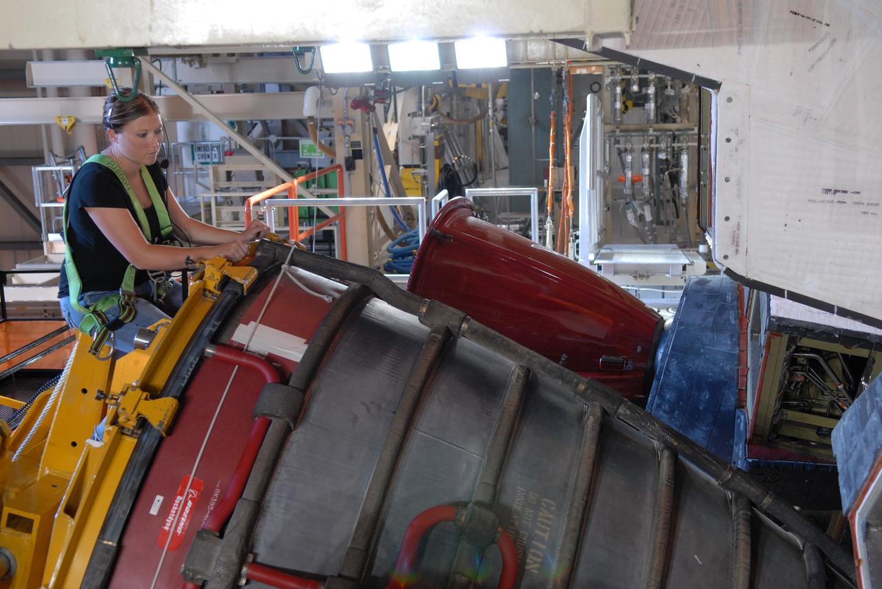 CAPE CANAVERAL, Fla. – At NASA's Kennedy Space Center in Florida, a technician using a Hyster forklift begins removing one of the three main engines on space shuttle Discovery.  Engine removal is part of the post-landing processing.  Discovery completed the STS-119 mission March 28 with a landing at Kennedy's Shuttle Landing Facility.  Each engine is 14 feet long, weighs about 6,700 pounds, and is 7.5 feet in diameter at the end of the nozzle. Discovery next will be used on the STS-128 mission to deliver supplies and equipment to the International Space Station.  The launch is targeted for Aug. 6.  Photo credit: NASA/Tim Jacobs