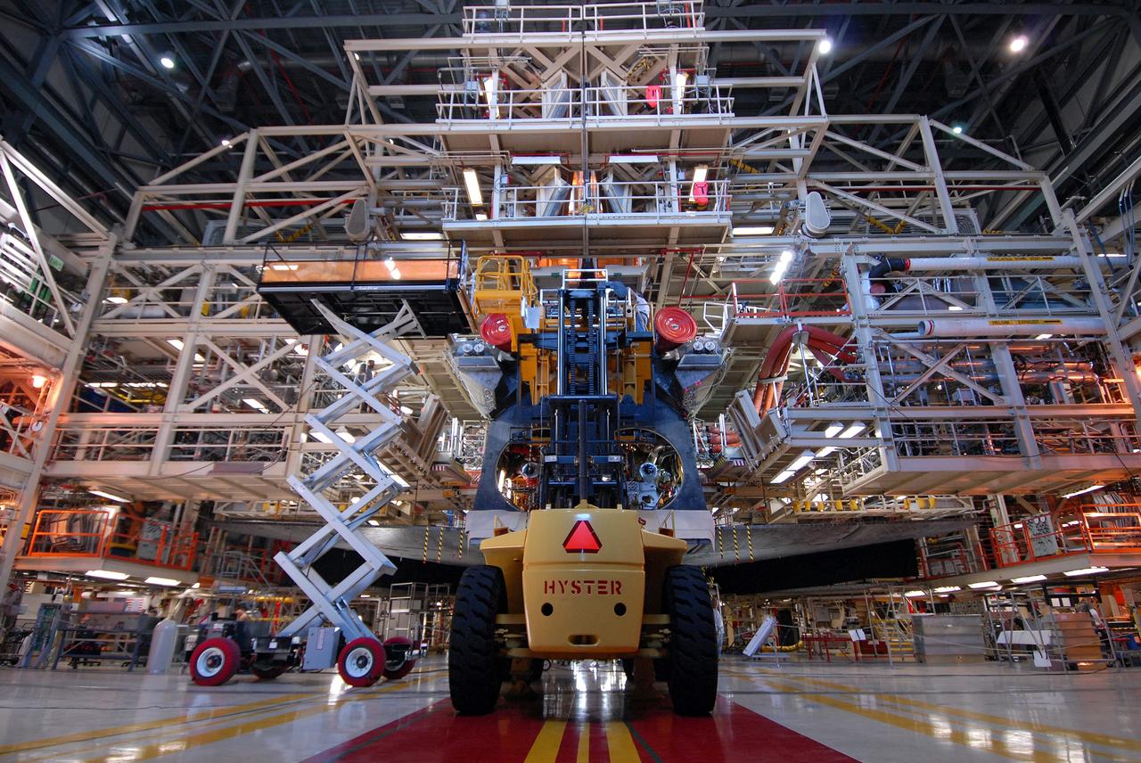 CAPE CANAVERAL, Fla. – At NASA's Kennedy Space Center in Florida, the Hyster forklift is ready to move away from space shuttle Discovery after removing one of the three main engines. Engine removal is part of the post-landing processing.  Discovery completed the STS-119 mission March 28 with a landing at Kennedy's Shuttle Landing Facility.  Each engine is 14 feet long, weighs about 6,700 pounds, and is 7.5 feet in diameter at the end of the nozzle. Discovery next will be used on the STS-128 mission to deliver supplies and equipment to the International Space Station.  The launch is targeted for Aug. 6.  Photo credit: NASA/Tim Jacobs