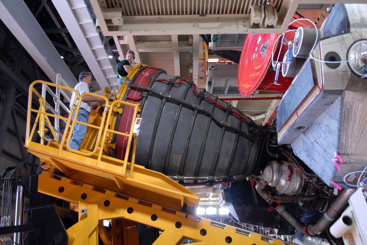 CAPE CANAVERAL, Fla. – At NASA's Kennedy Space Center in Florida, technicians plan the next move after removal of one of the three main engines on space shuttle Discovery.  Engine removal is part of the post-landing processing.  Discovery completed the STS-119 mission March 28 with a landing at Kennedy's Shuttle Landing Facility.  Each engine is 14 feet long, weighs about 6,700 pounds, and is 7.5 feet in diameter at the end of the nozzle. Discovery next will be used on the STS-128 mission to deliver supplies and equipment to the International Space Station.  The launch is targeted for Aug. 6.  Photo credit: NASA/Tim Jacobs