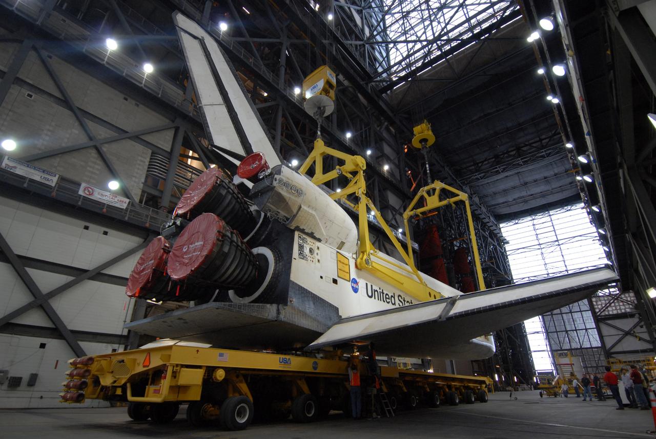 CAPE CANAVERAL, Fla. – In the transfer aisle of the Vehicle Assembly Building at NASA's Kennedy Space Center in Florida, cranes are fitted onto space shuttle Endeavour to be lifted into High Bay 1. In the high bay, the shuttle will be attached to the external fuel tank and solid rocket boosters already installed on the mobile launcher platform. Endeavour is scheduled to roll out to Launch Pad 39B on April 17. Endeavour will be prepared on the pad for liftoff in the unlikely event that a rescue mission is necessary following space shuttle Atlantis' launch on the STS-125 mission to service the Hubble Space Telescope. After Atlantis is cleared to land, Endeavour will move to Launch Pad 39A for its upcoming STS-127 mission to the International Space Station, targeted to launch in mid-June. Photo credit: NASA/Troy Cryder