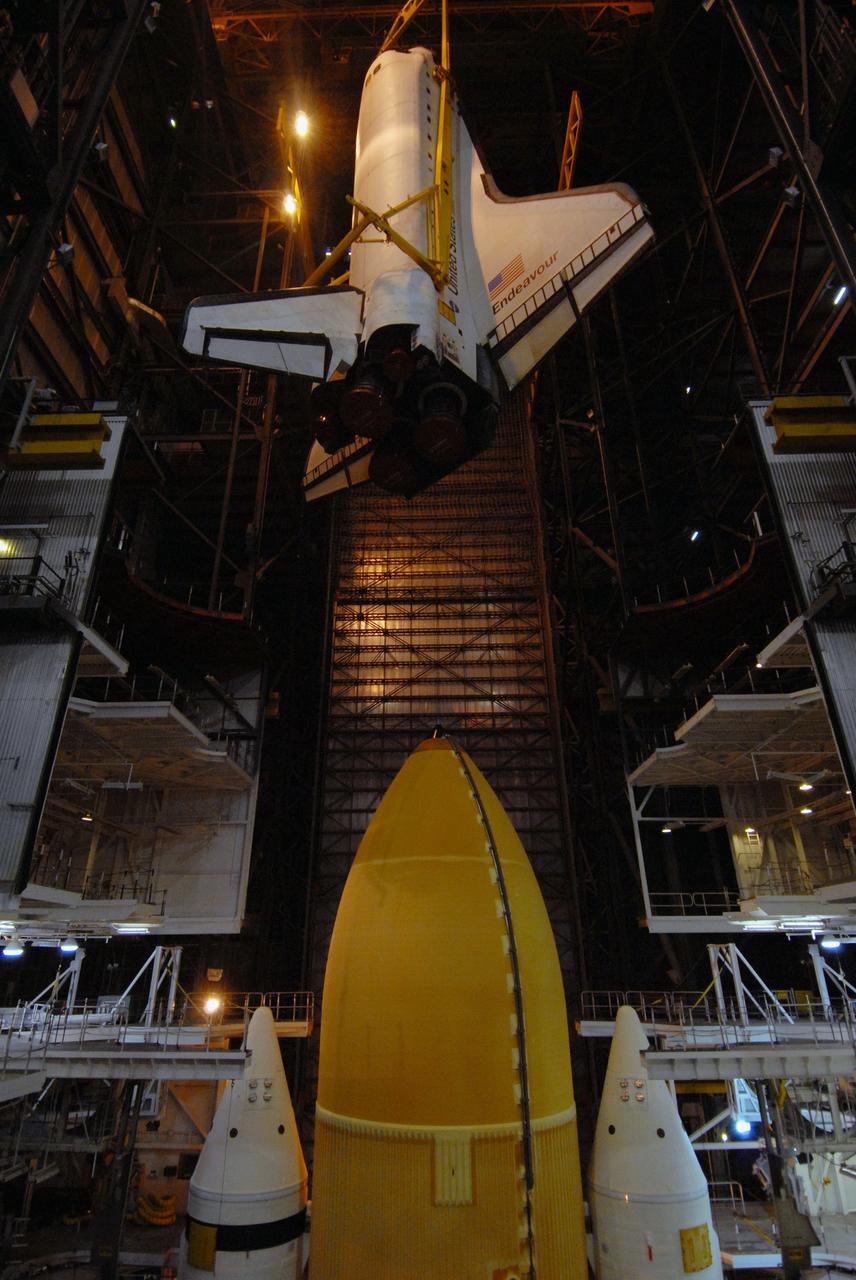 CAPE CANAVERAL, Fla. – In the Vehicle Assembly Building at NASA's Kennedy Space Center in Florida, space shuttle Endeavour is lowered into High Bay 1 toward the external tank and solid rocket boosters already installed on the mobile launcher platform. Endeavour is scheduled to roll out to Launch Pad 39B on April 17. Endeavour will be prepared on the pad for liftoff in the unlikely event that a rescue mission is necessary following space shuttle Atlantis' launch on the STS-125 mission to service the Hubble Space Telescope. After Atlantis is cleared to land, Endeavour will move to Launch Pad 39A for its upcoming STS-127 mission to the International Space Station, targeted to launch in mid-June. Photo credit: NASA/Troy Cryder