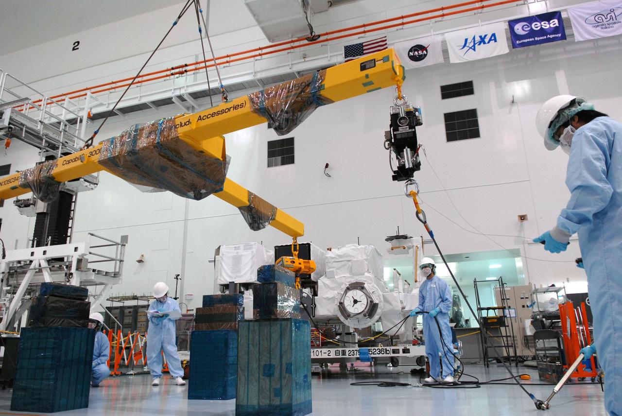 CAPE CANAVERAL, Fla. – In the Space Station Processing Facility at NASA's Kennedy Space Center in Florida,  workers maneuver a crane that will be attached to the Kibo Experiment Logistics Module Exposed Section, or ELM-ES, behind them.  The ELM-ES will be moved to a workstand. The ELM-ES is one of the final components of the Japan Aerospace Exploration Agency's Kibo laboratory for the International Space Station.  It can provide payload storage space and can carry up to three payloads at launch. The ELM-ES will be carried aboard space shuttle Endeavour on the STS-127 mission targeted for launch Aug. 6.  Photo credit: NASA/Jack Pfaller