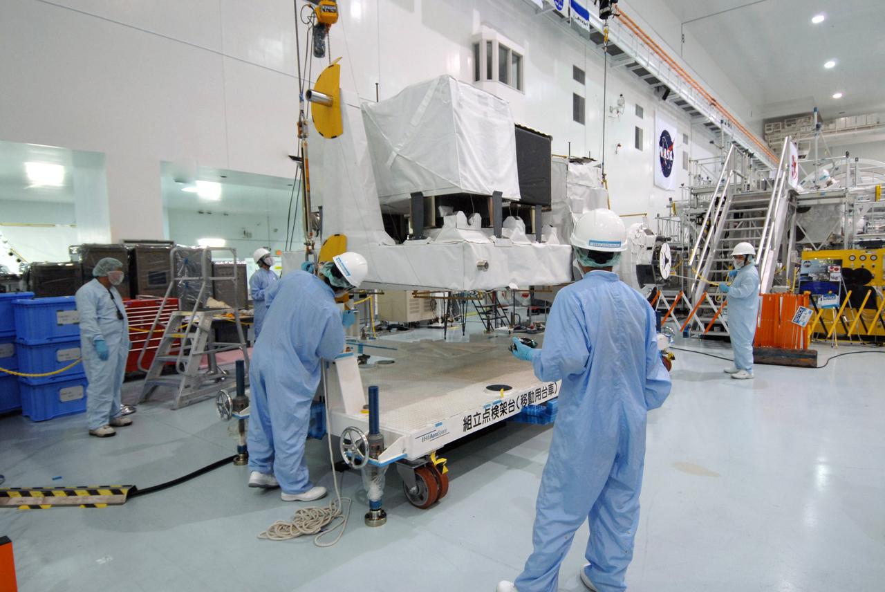 CAPE CANAVERAL, Fla. – In the Space Station Processing Facility at NASA's Kennedy Space Center in Florida, workers adjust cables lifting the Kibo Experiment Logistics Module Exposed Section, or ELM-ES.  The ELM-ES will be moved to a workstand. The ELM-ES is one of the final components of the Japan Aerospace Exploration Agency's Kibo laboratory for the International Space Station.  It can provide payload storage space and can carry up to three payloads at launch. The ELM-ES will be carried aboard space shuttle Endeavour on the STS-127 mission targeted for launch June 13.  Photo credit: NASA/Jack Pfaller