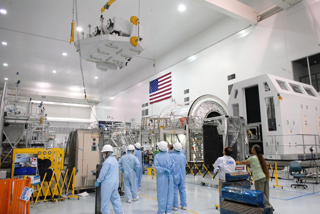 CAPE CANAVERAL, Fla. – In the Space Station Processing Facility at NASA's Kennedy Space Center in Florida, the Kibo Experiment Logistics Module Exposed Section, or ELM-ES, is carried high above the floor as it is moved to a workstand, at right. The ELM-ES is one of the final components of the Japan Aerospace Exploration Agency's Kibo laboratory for the International Space Station.  It can provide payload storage space and can carry up to three payloads at launch. The ELM-ES will be carried aboard space shuttle Endeavour on the STS-127 mission targeted for launch June 13.  Photo credit: NASA/Jack Pfaller