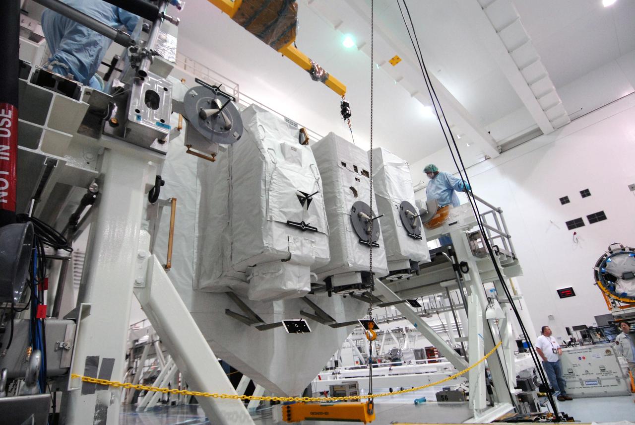 CAPE CANAVERAL, Fla. – In the Space Station Processing Facility at NASA's Kennedy Space Center in Florida, the vertical Kibo Experiment Logistics Module Exposed Section, or ELM-ES, is lowered onto the workstand. The ELM-ES is one of the final components of the Japan Aerospace Exploration Agency's Kibo laboratory for the International Space Station.  It can provide payload storage space and can carry up to three payloads at launch. The ELM-ES will be carried aboard space shuttle Endeavour on the STS-127 mission targeted for launch June 13.  Photo credit: NASA/Jack Pfaller