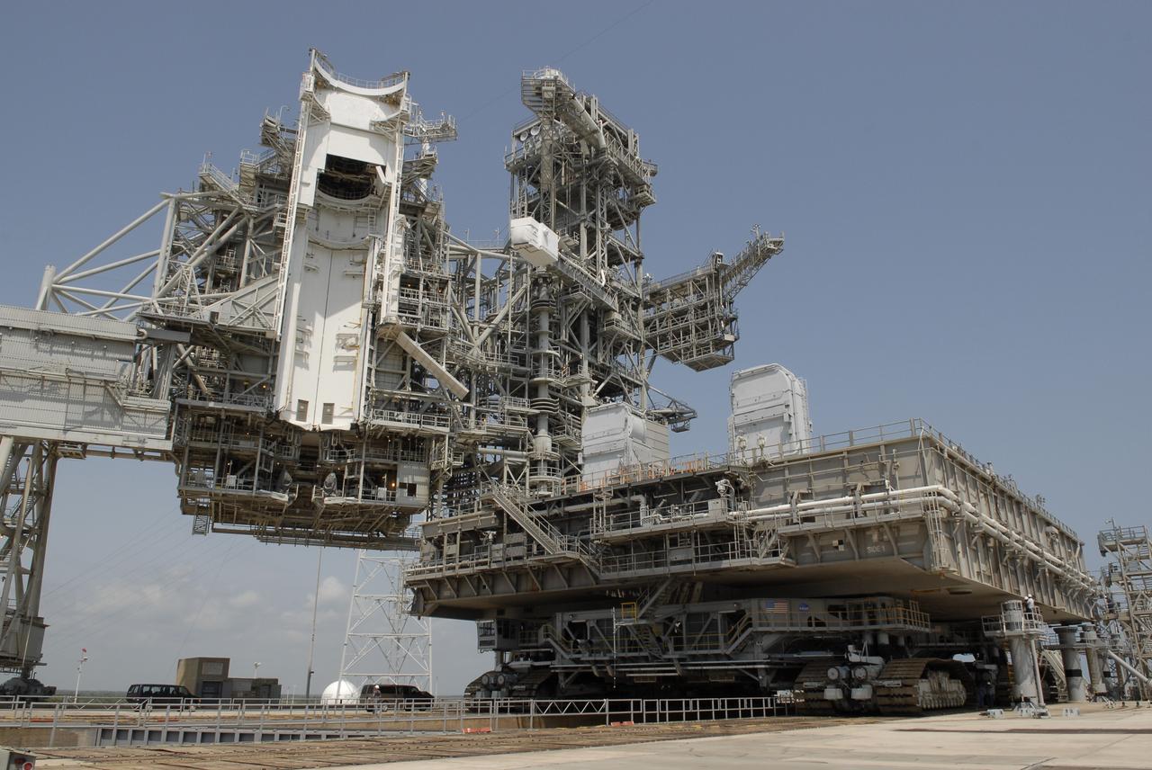 CAPE CANAVERAL, Fla. – At NASA's Kennedy Space Center in Florida, the mobile launcher platform that was turned over from the shuttle program to the Constellation Program last month is being moved from Kennedy's Launch Pad 39B via the crawler-transporter underneath. At left is seen the payload changeout room in the open rotating service structure. The platform will be rolled into the Vehicle Assembly Building's High Bay 3 in preparation for the Ares I-X flight test this summer. Ares I-X is the test vehicle for the Ares I, which is part of the Constellation Program to return men to the moon and beyond. Ground Control System hardware was installed in MLP-1 in December 2008. The platform was moved to the launch pad to check out the installed hardware with the Launch Control Center Firing Room 1 equipment, using the actual circuits that will be used when the fully stacked Ares I-X vehicle is rolled out later this year for launch. Photo credit: NASA/Kim Shiflett