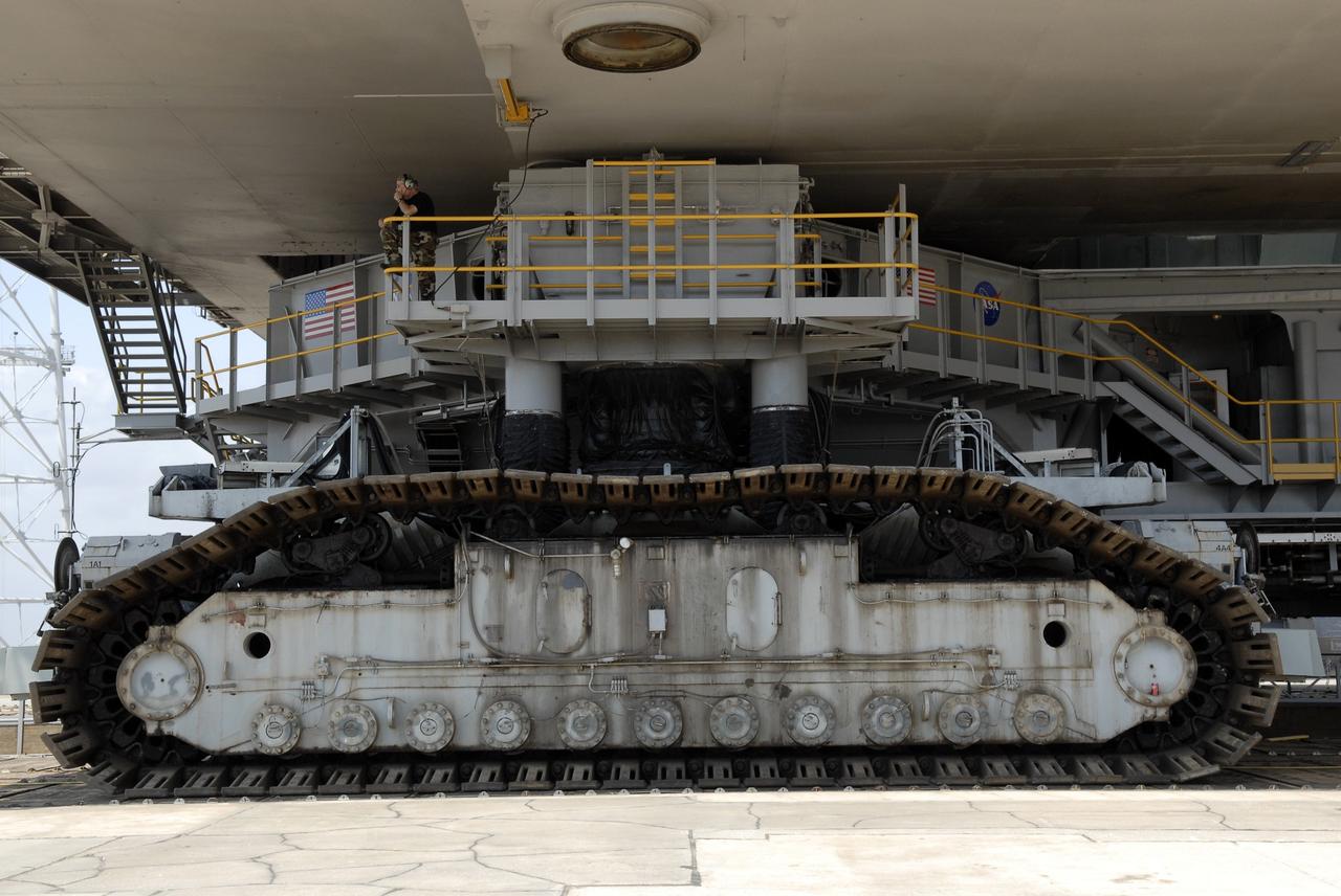 CAPE CANAVERAL, Fla. – At NASA's Kennedy Space Center in Florida, the crawler-transporter is underneath the mobile launcher platform to move it from Kennedy's Launch Pad 39B  to the Vehicle Assembly Building's High Bay 3 in preparation for the Ares I-X flight test this summer. The platform was turned over from the shuttle program to the Constellation Program last month. Ares I-X is the test vehicle for the Ares I, which is part of the Constellation Program to return men to the moon and beyond.  Ground Control System hardware was installed in MLP-1 in December 2008.  The platform was moved to the launch pad to check out the installed hardware with the Launch Control Center Firing Room 1 equipment, using the actual circuits that will be used when the fully stacked Ares I-X vehicle is rolled out later this year for launch.  Photo credit: NASA/Kim Shiflett