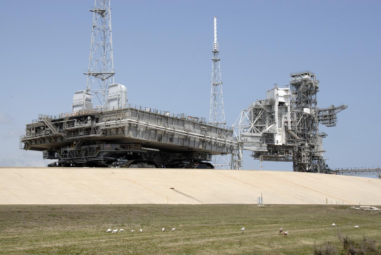 CAPE CANAVERAL, Fla. – At NASA's Kennedy Space Center in Florida, the mobile launcher platform that was turned over from the shuttle program to the Constellation Program last month is being moved from Kennedy's Launch Pad 39B via the crawler-transporter underneath. The platform will be rolled into the Vehicle Assembly Building's High Bay 3 in preparation for the Ares I-X flight test this summer. Ares I-X is the test vehicle for the Ares I, which is part of the Constellation Program to return men to the moon and beyond.  Ground Control System hardware was installed in MLP-1 in December 2008.  The platform was moved to the launch pad to check out the installed hardware with the Launch Control Center Firing Room 1 equipment, using the actual circuits that will be used when the fully stacked Ares I-X vehicle is rolled out later this year for launch.  Photo credit: NASA/Kim Shiflett