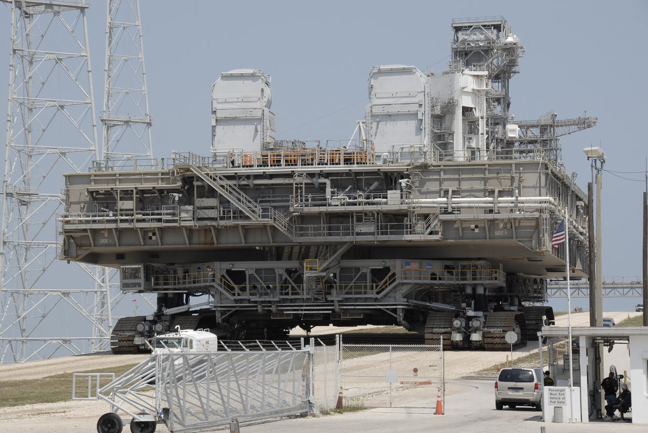 CAPE CANAVERAL, Fla. – At NASA's Kennedy Space Center in Florida, the mobile launcher platform that was turned over from the shuttle program to the Constellation Program last month moves off Kennedy's Launch Pad 39B via the crawler-transporter underneath. The platform will be rolled into the Vehicle Assembly Building's High Bay 3 in preparation for the Ares I-X flight test this summer.  Ares I-X is the test vehicle for the Ares I, which is part of the Constellation Program to return men to the moon and beyond.  Ground Control System hardware was installed in MLP-1 in December 2008.  The platform was moved to the launch pad to check out the installed hardware with the Launch Control Center Firing Room 1 equipment, using the actual circuits that will be used when the fully stacked Ares I-X vehicle is rolled out later this year for launch.  Photo credit: NASA/Kim Shiflett