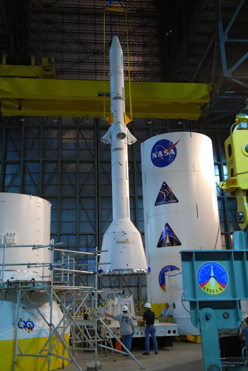 CAPE CANAVERAL, Fla. – In high bay 4 of the Vehicle Assembly Building at NASA's Kennedy Space Center in Florida, the Ares I-X simulated launch abort system, or LAS, is suspended vertically above its stand.  The LAS will be lifted higher and moved for assembly with the crew module simulator. Ares I-X is the flight test vehicle for the Ares I, which is part of the Constellation Program to return men to the moon and beyond. Ares I is the essential core of a safe, reliable, cost-effective space transportation system that eventually will carry crewed missions back to the moon, on to Mars and out into the solar system. Ares I-X is targeted for launch in July 2009. Photo credit: NASA/Jack Pfaller