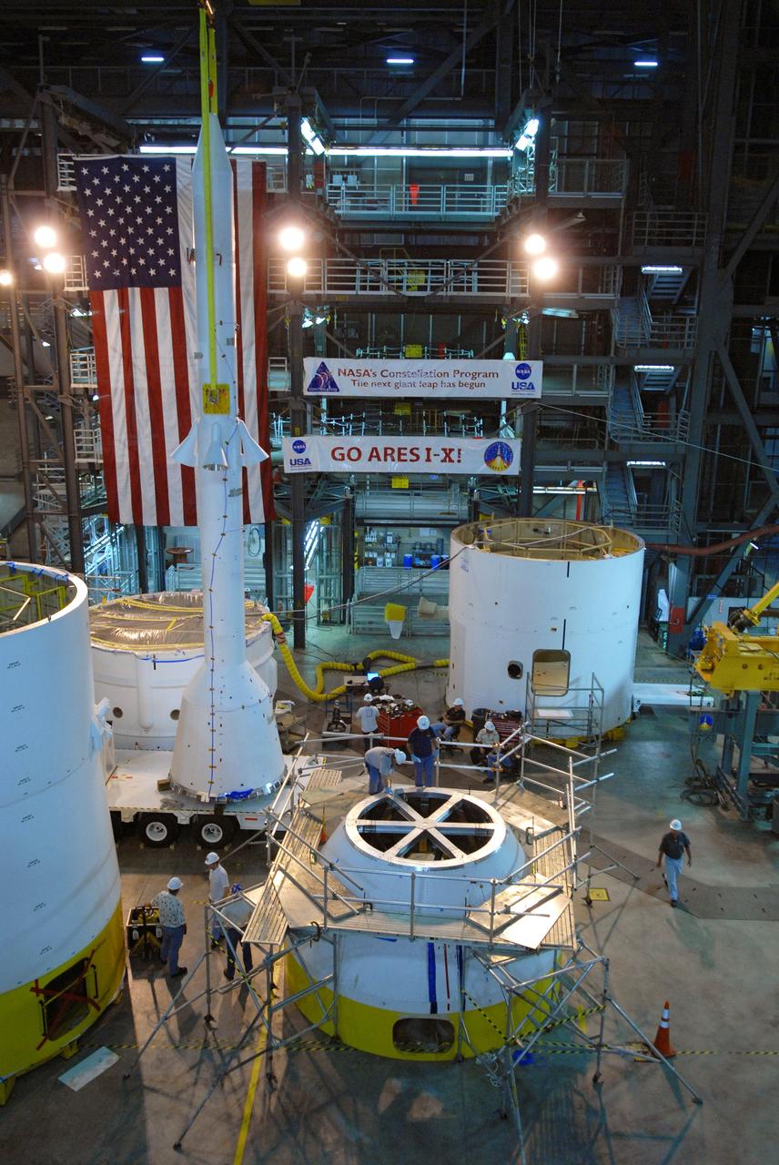 CAPE CANAVERAL, Fla. – In high bay 4 of the Vehicle Assembly Building at NASA's Kennedy Space Center in Florida, the Ares I-X simulated launch abort system, or LAS, (left of center) is being moved to the crew module simulator (center) for assembly. Ares I-X is the flight test vehicle for the Ares I, which is part of the Constellation Program to return men to the moon and beyond. Ares I is the essential core of a safe, reliable, cost-effective space transportation system that eventually will carry crewed missions back to the moon, on to Mars and out into the solar system. Ares I-X is targeted for launch in July 2009. Photo credit: NASA/Jack Pfaller