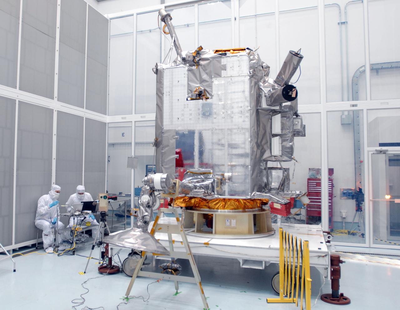CAPE CANAVERAL, Fla. – At Astrotech Space Operations in Titusville, Fla., technicians check data (left) as the range of motion is tested on the high-gain antenna (foreground) for the Lunar Reconnaissance Orbiter. The orbiter will carry seven instruments to provide scientists with detailed maps of the lunar surface and enhance our understanding of the moon's topography, lighting conditions, mineralogical composition and natural resources. Information gleaned from LRO will be used to select safe landing sites, determine locations for future lunar outposts and help mitigate radiation dangers to astronauts.  Launch of LRO is targeted no earlier than June 2.  Photo credit: NASA/Jim Grossmann