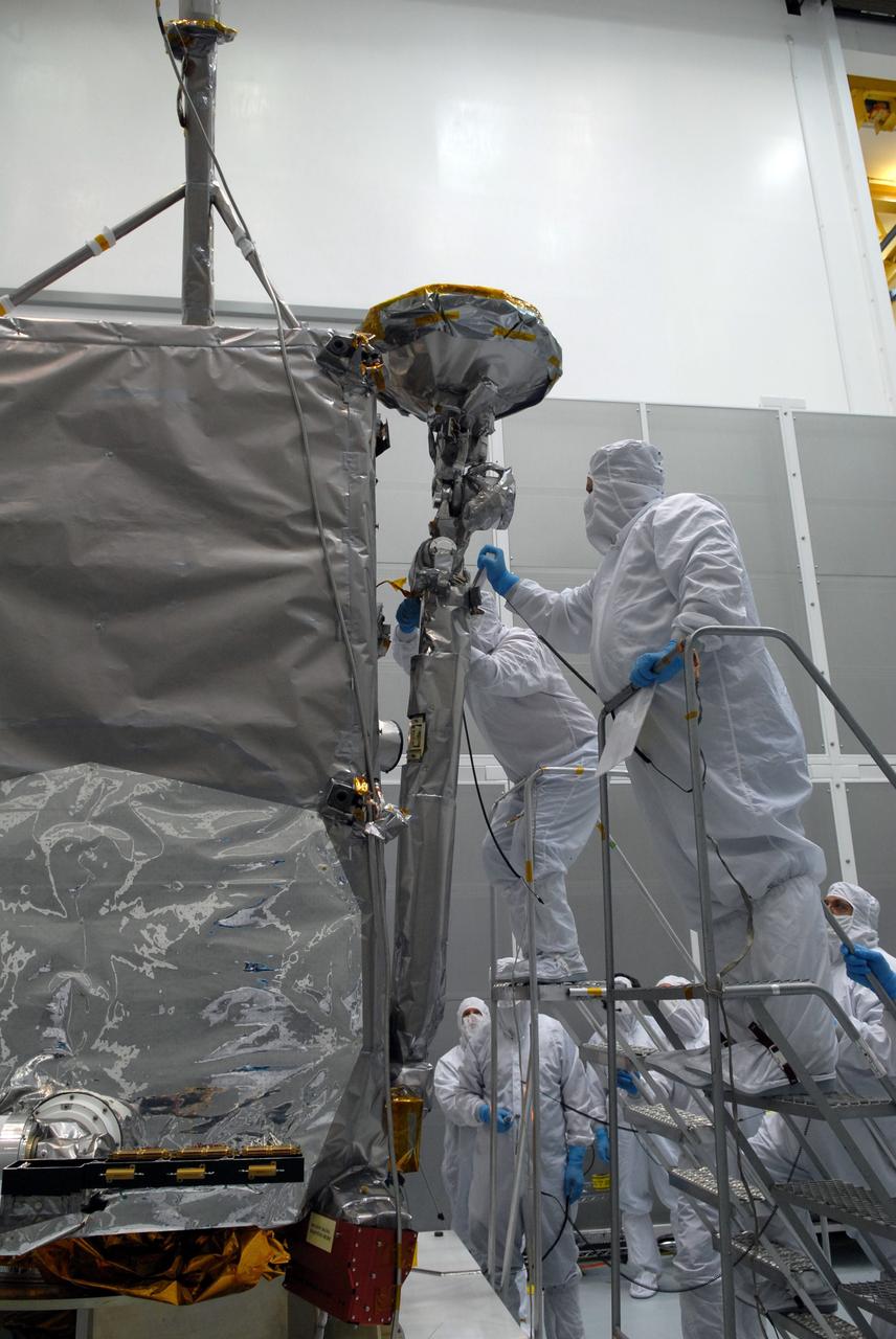 CAPE CANAVERAL, Fla. – At Astrotech Space Operations in Titusville, Fla., technicians maneuver NASA's Lunar Reconnaissance Orbiter's high-gain antenna into place for stowage.  The antenna completed a range of motion test.  The orbiter will carry seven instruments to provide scientists with detailed maps of the lunar surface and enhance our understanding of the moon's topography, lighting conditions, mineralogical composition and natural resources. Information gleaned from LRO will be used to select safe landing sites, determine locations for future lunar outposts and help mitigate radiation dangers to astronauts.  Launch of LRO is targeted no earlier than June 2.   Photo credit: NASA/Jack Pfaller