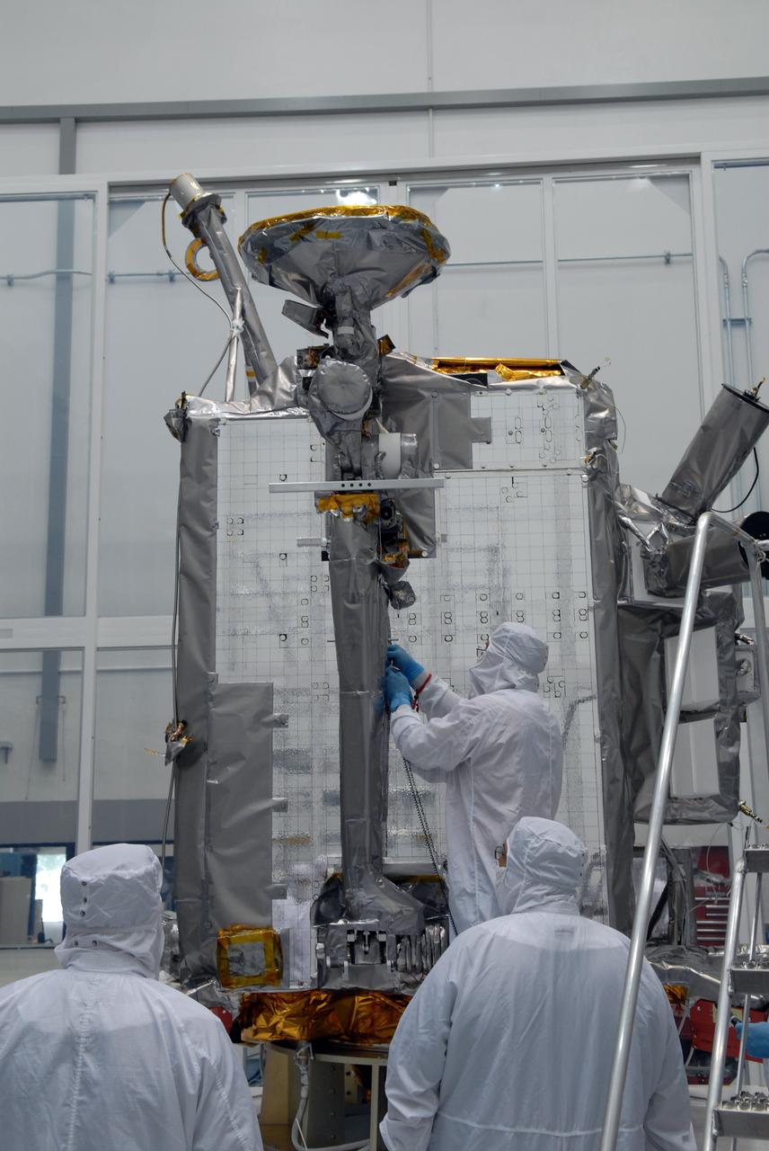 CAPE CANAVERAL, Fla. – At Astrotech Space Operations in Titusville, Fla., technicians secure NASA's Lunar Reconnaissance Orbiter's high-gain antenna into place for stowage.  The antenna completed a range of motion test.  The orbiter will carry seven instruments to provide scientists with detailed maps of the lunar surface and enhance our understanding of the moon's topography, lighting conditions, mineralogical composition and natural resources. Information gleaned from LRO will be used to select safe landing sites, determine locations for future lunar outposts and help mitigate radiation dangers to astronauts.  Launch of LRO is targeted no earlier than June 2.   Photo credit: NASA/Jack Pfaller