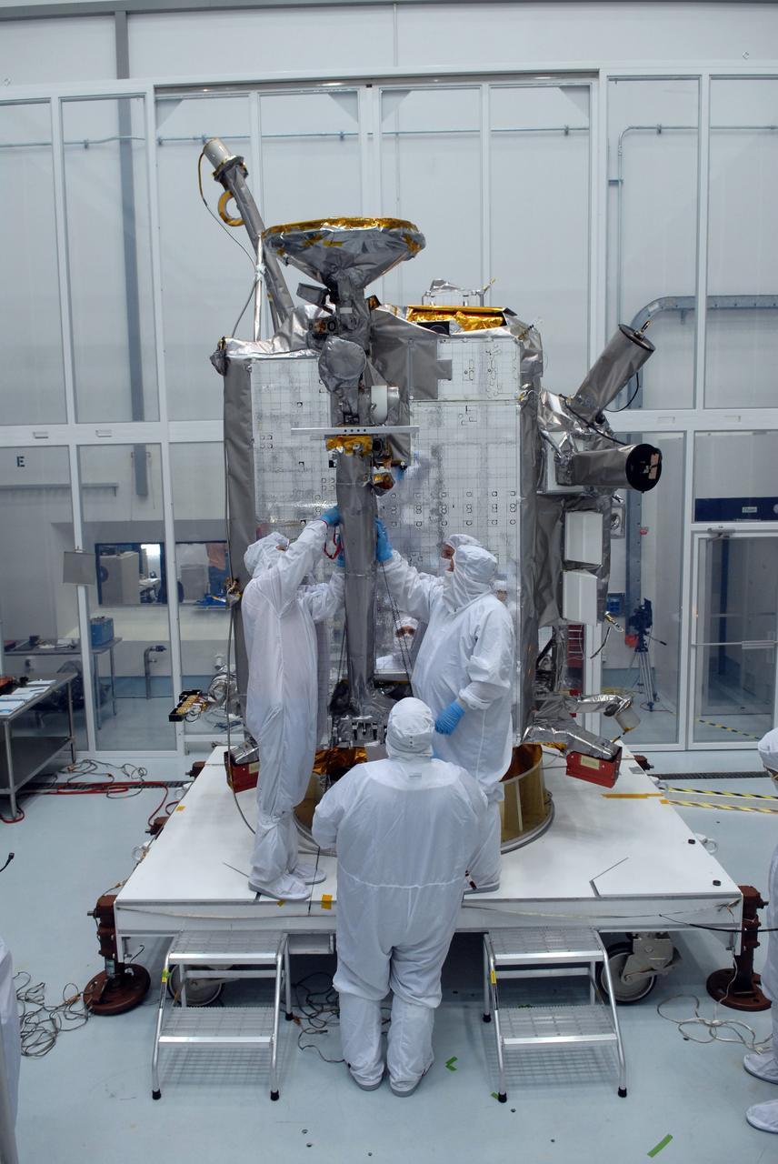 CAPE CANAVERAL, Fla. – At Astrotech Space Operations in Titusville, Fla., technicians secure NASA's Lunar Reconnaissance Orbiter's high-gain antenna into place for stowage.  The antenna completed a range of motion test.  The orbiter will carry seven instruments to provide scientists with detailed maps of the lunar surface and enhance our understanding of the moon's topography, lighting conditions, mineralogical composition and natural resources. Information gleaned from LRO will be used to select safe landing sites, determine locations for future lunar outposts and help mitigate radiation dangers to astronauts.  Launch of LRO is targeted no earlier than June 2.   Photo credit: NASA/Jack Pfaller