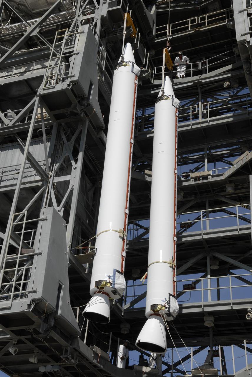 CAPE CANAVERAL, Fla. – On Launch Complex 17-B at Cape Canaveral Air Force Station, solid rocket boosters are lifted into the mobile service tower. The boosters will be attached to the Delta II rocket that will launch the STSS Demonstrator spacecraft. The STSS Demonstrators is a midcourse tracking technology demonstrator and is part of an evolving ballistic missile defense system. STSS is capable of tracking objects after boost phase and provides trajectory information to other sensors. It will be launched by NASA for the Missile Defense Agency on July 29. Photo credit: NASA/Kim Shiflett