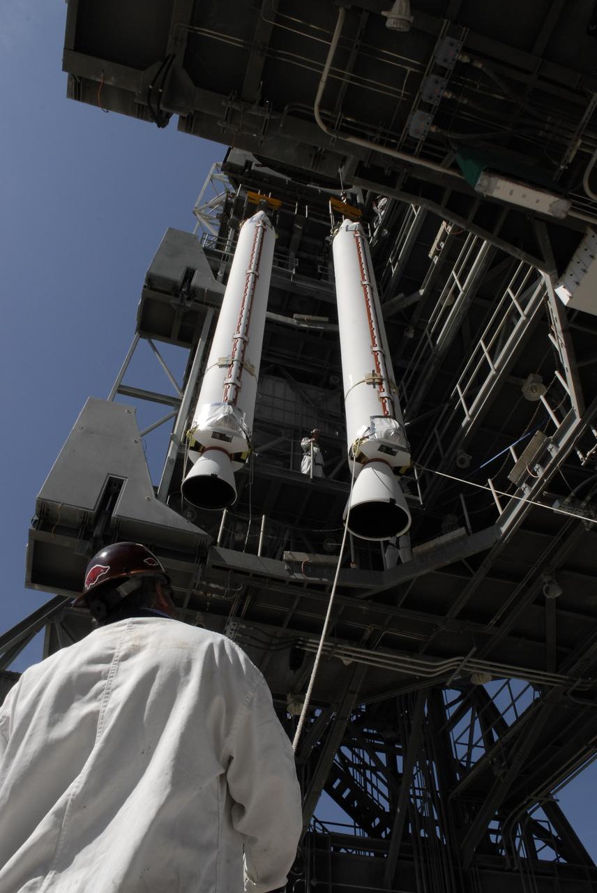 CAPE CANAVERAL, Fla. – On Launch Complex 17-B at Cape Canaveral Air Force Station, solid rocket boosters are lifted into the mobile service tower. The boosters will be attached to the Delta II rocket that will launch the STSS Demonstrator spacecraft. The STSS Demonstrators is a midcourse tracking technology demonstrator and is part of an evolving ballistic missile defense system. STSS is capable of tracking objects after boost phase and provides trajectory information to other sensors. It will be launched by NASA for the Missile Defense Agency on July 29. Photo credit: NASA/Kim Shiflett
